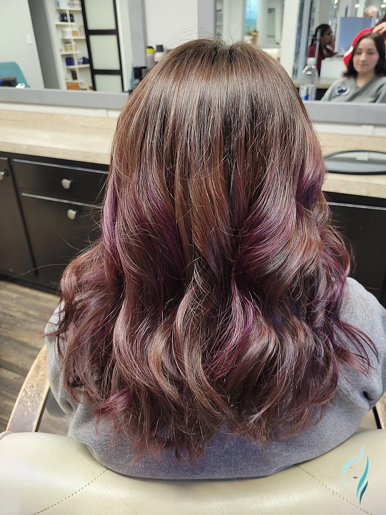 Brunette hair with plum highlights and soft waves at Changing Times Hair Designs, State College, PA.