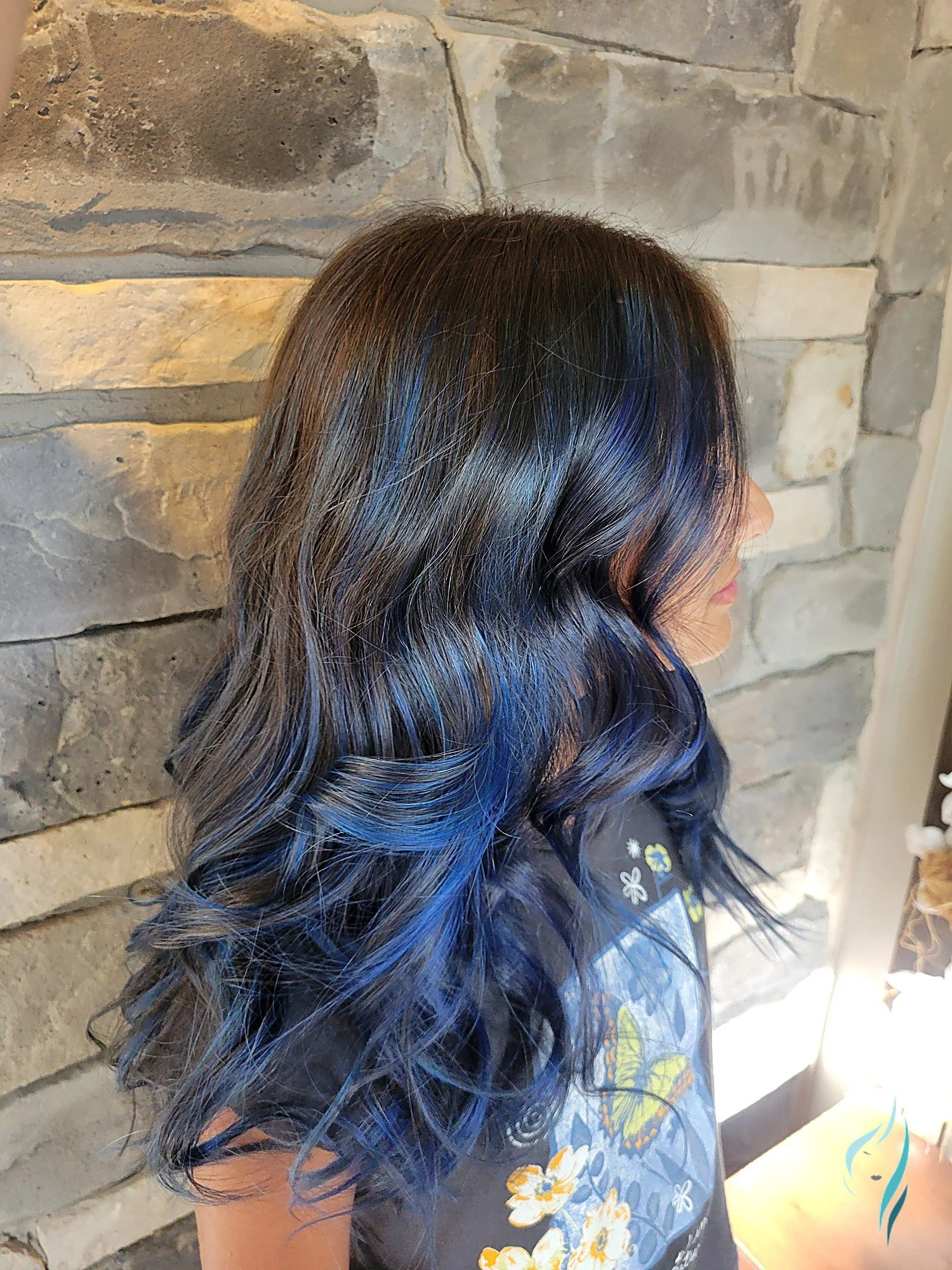 Dark hair with vibrant blue highlights and waves by Changing Times Hair Designs, State College, PA.