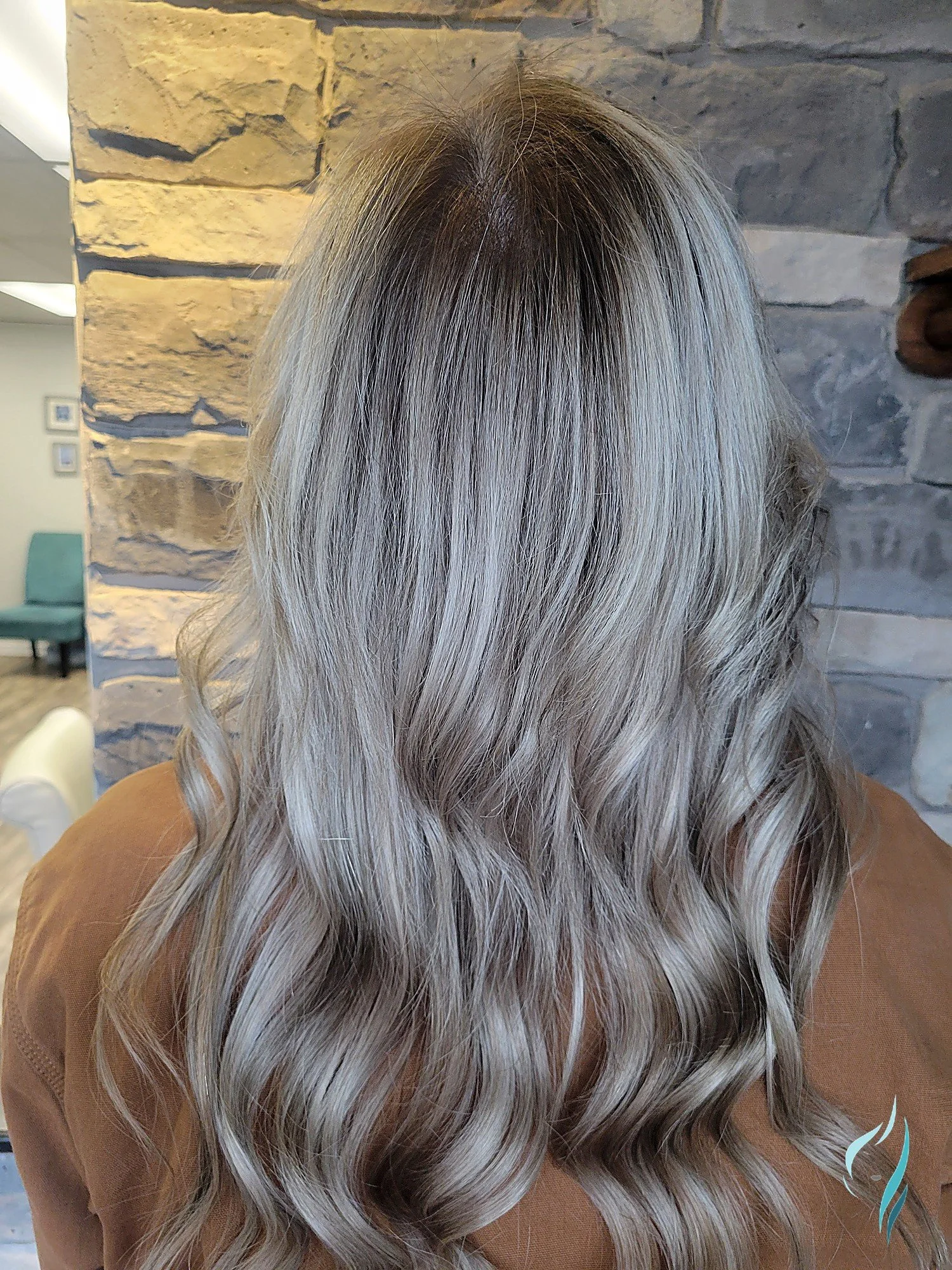 Rooted icy blonde balayage with soft waves by Changing Times Hair Designs, State College, PA.