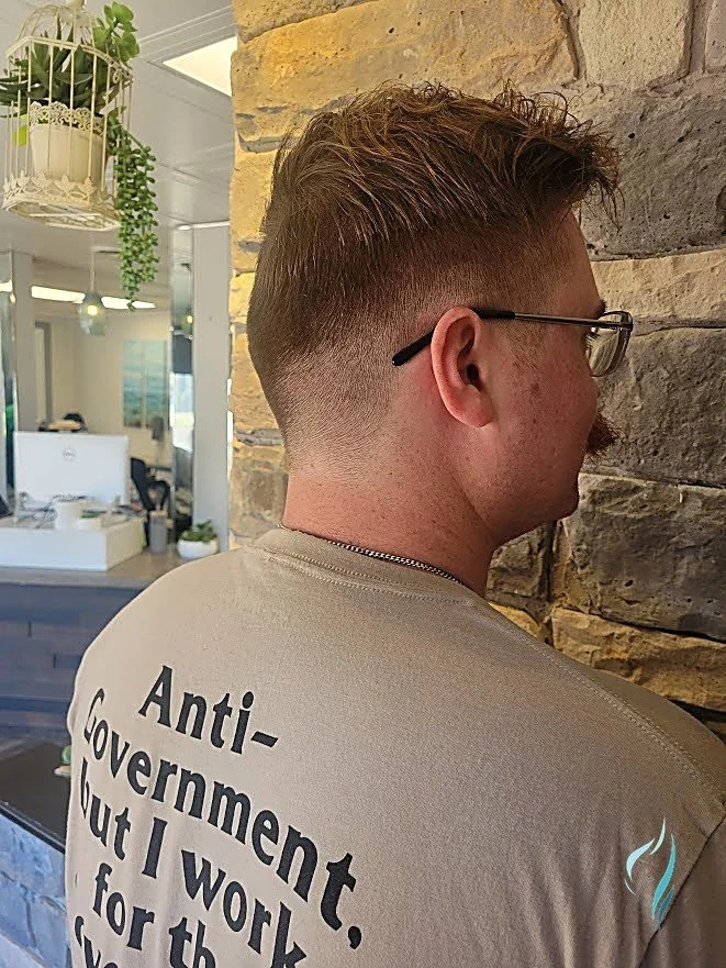 A sharp skin fade haircut with textured top by Changing Times Hair Designs, State College, PA.