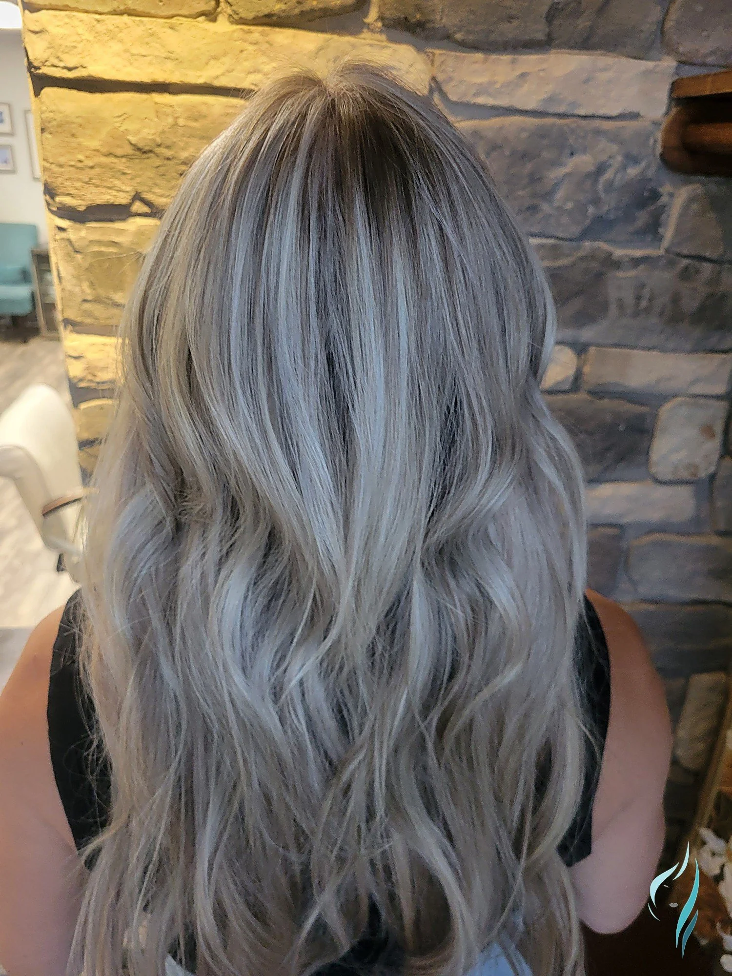 Long wavy icy blonde hair with a shadow root by Changing Times Hair Designs, State College, PA.