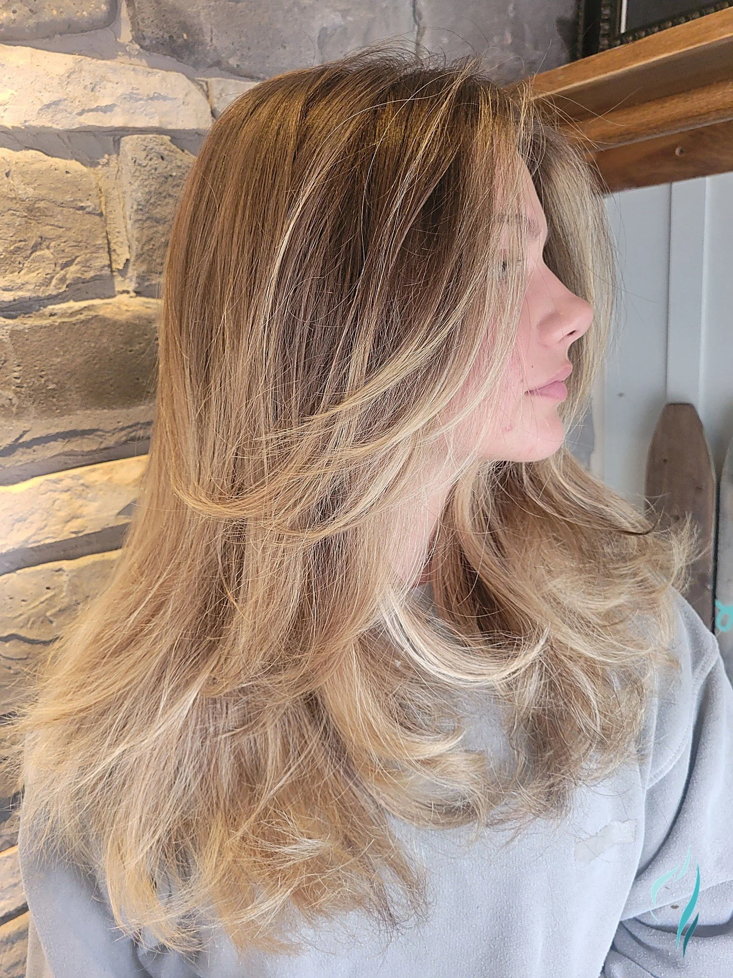 Dimensional blonde balayage with face-framing layers by Changing Times Hair Designs, State College, PA.