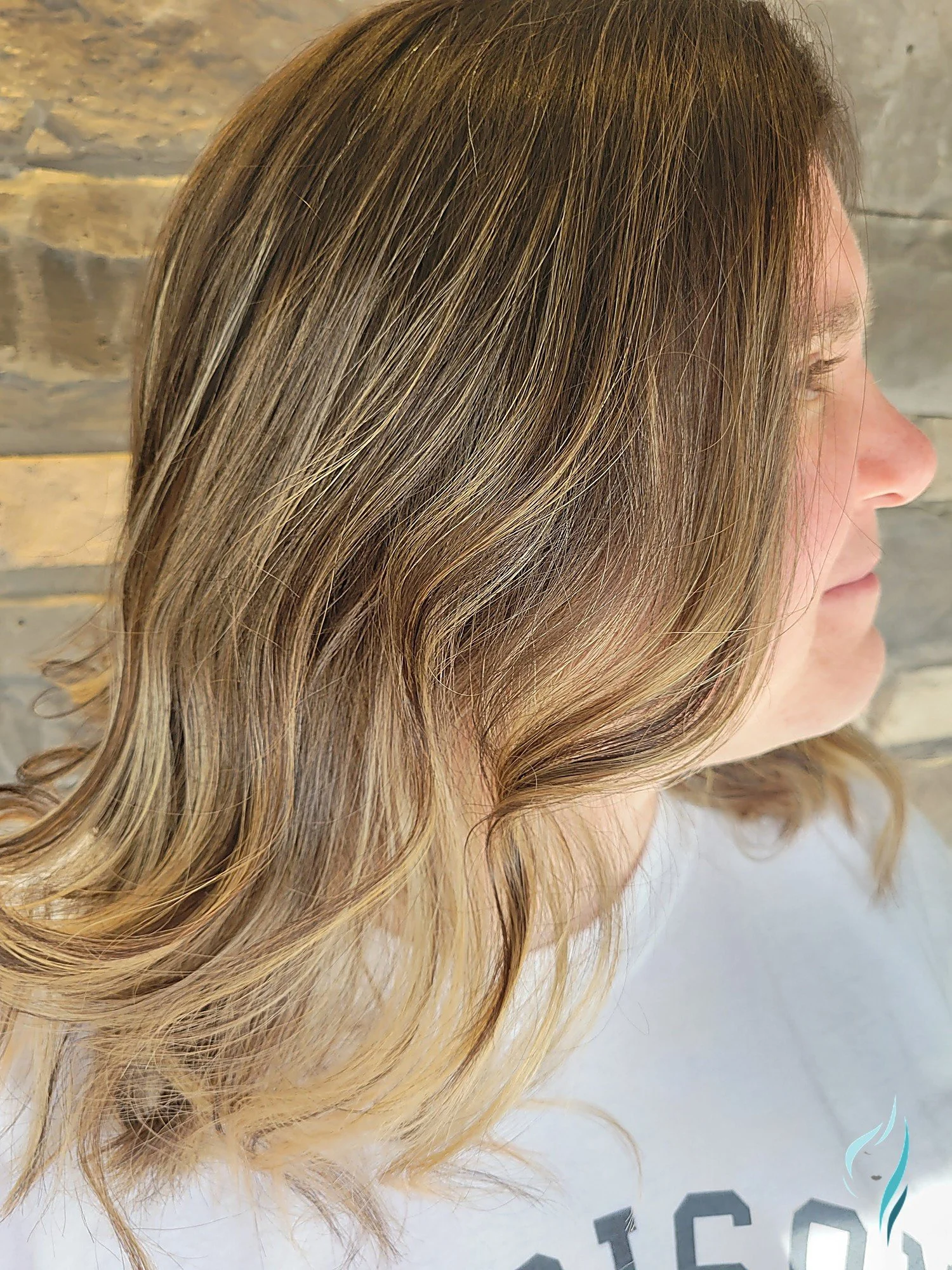 Dimensional blonde highlights on wavy hair at Changing Times Hair Designs, State College, PA.