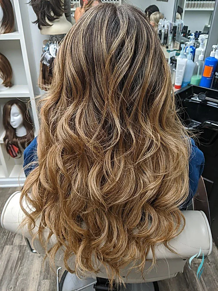 Warm caramel balayage with soft waves by Changing Times Hair Designs, State College, PA.