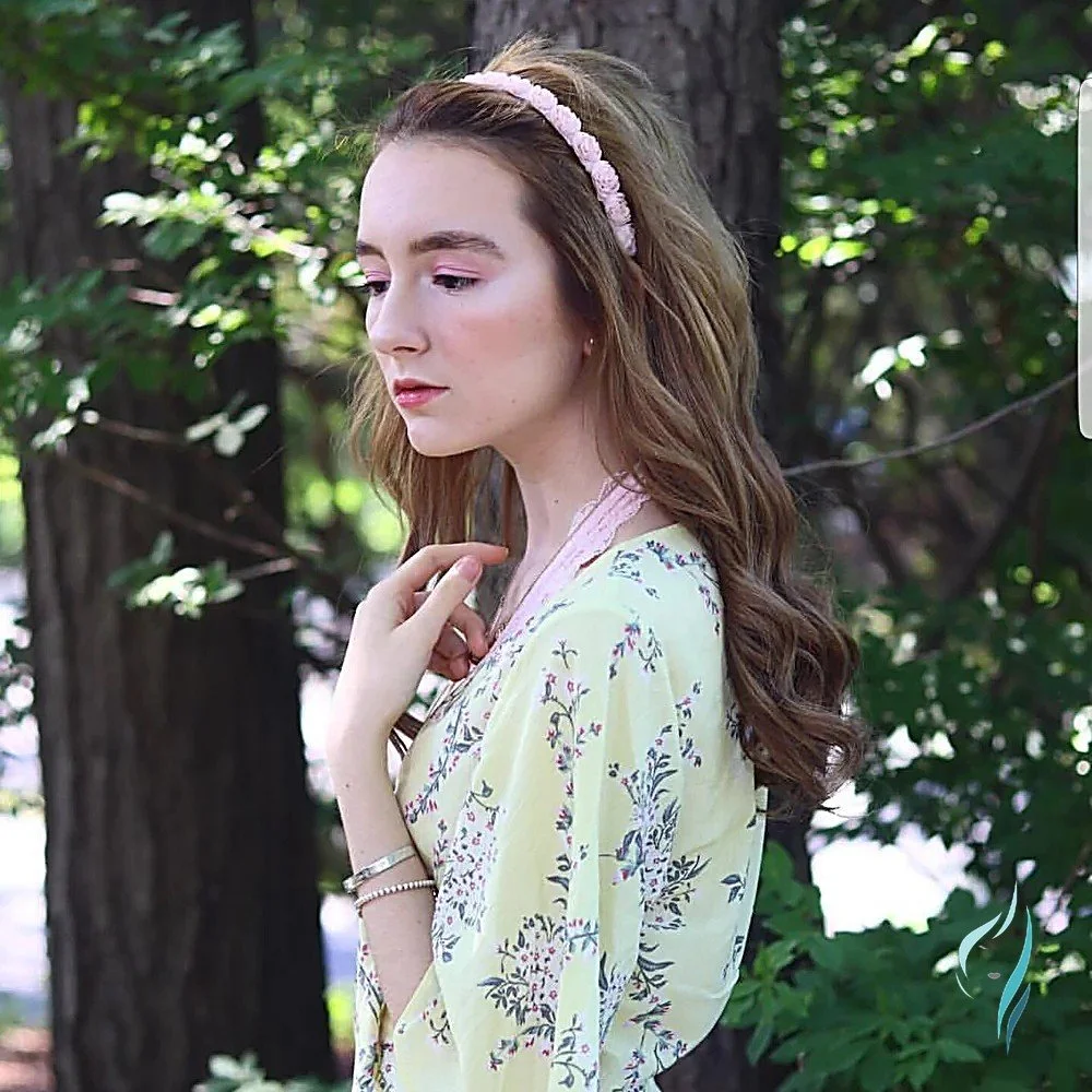 Long brown wavy hair styled with a pink floral headband at Changing Times Hair Designs, State College, PA.