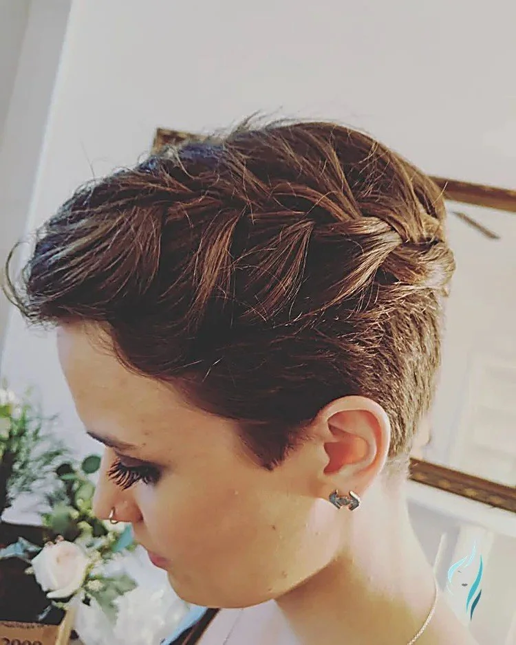 A trendy short brunette pixie cut with intricate braiding detail by Changing Times Hair Designs, State College, PA.