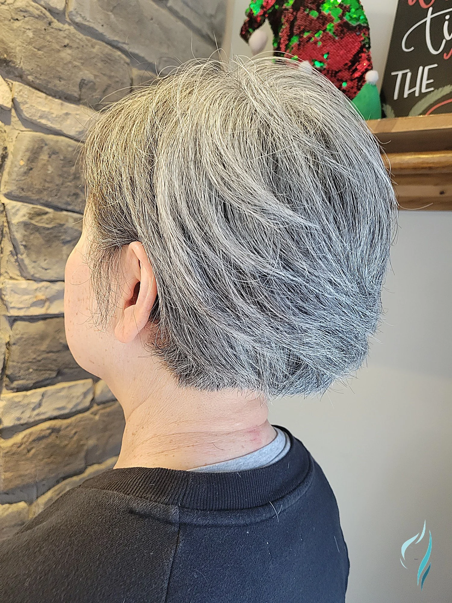 Short, precision-cut silver pixie hairstyle at Changing Times Hair Designs, State College, PA.