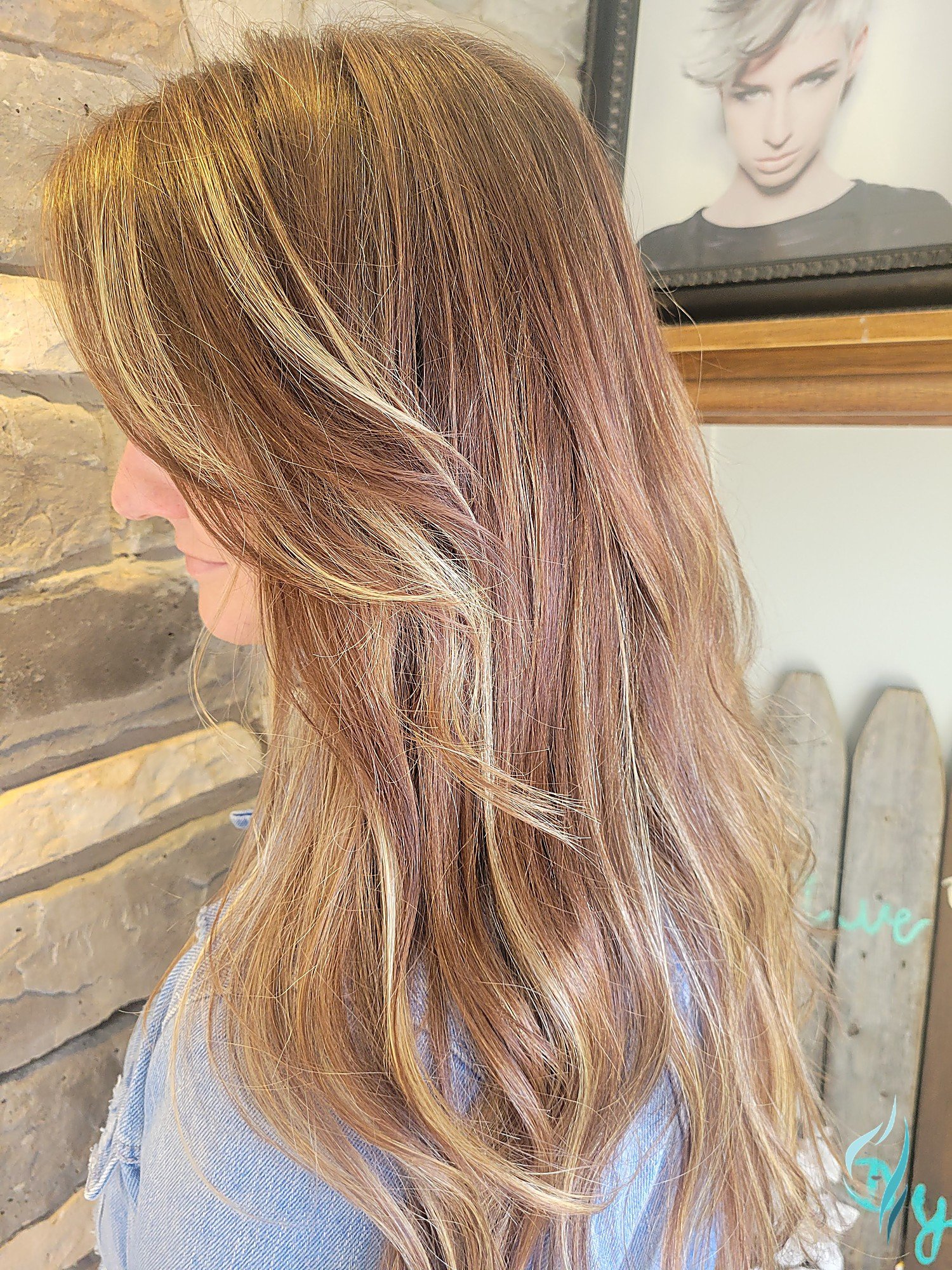 Long layered hair with golden balayage highlights at Changing Times Hair Designs, State College, PA.