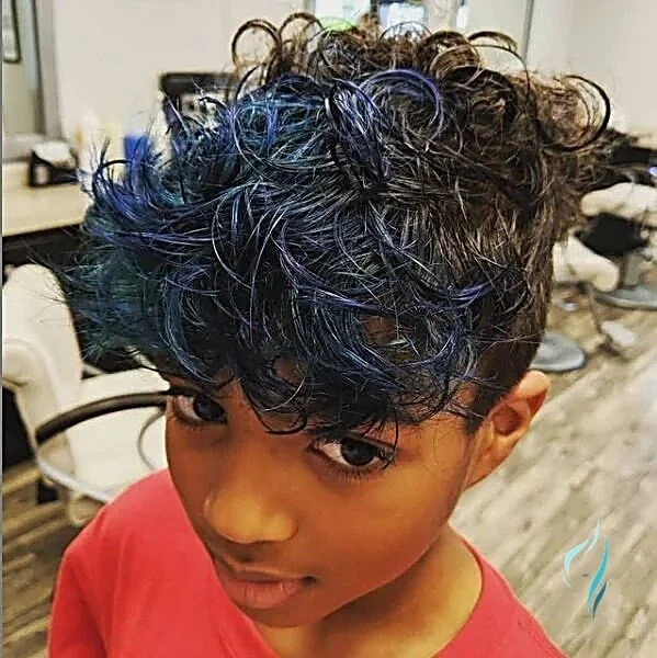 Short curly hair dyed a vibrant electric blue at Changing Times Hair Designs, State College, PA.