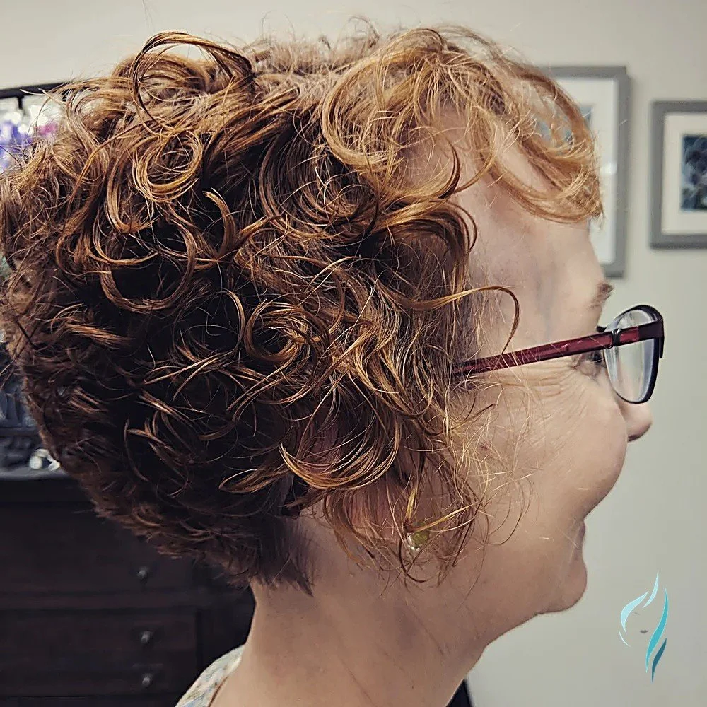 Stylish, short curly copper hairstyle at Changing Times Hair Designs, State College, PA.