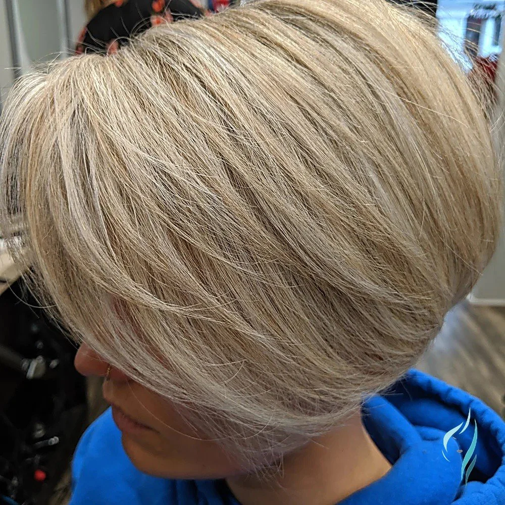 A precision blonde bob with dimensional highlights by Changing Times Hair Designs, State College, PA.