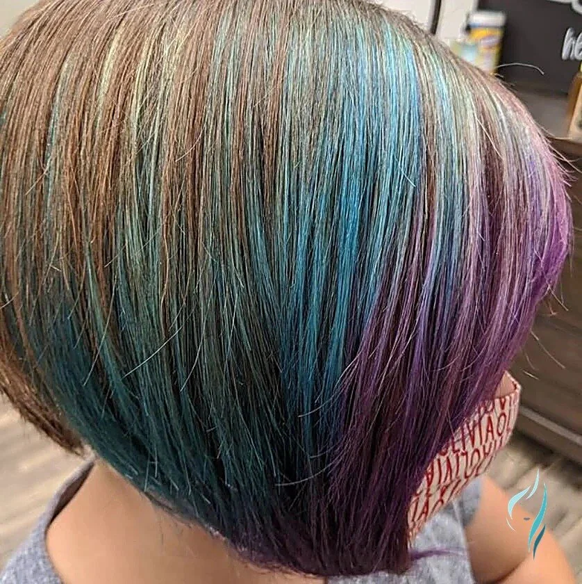 Vibrant teal and purple highlights in a short bob at Changing Times Hair Designs, State College, PA.