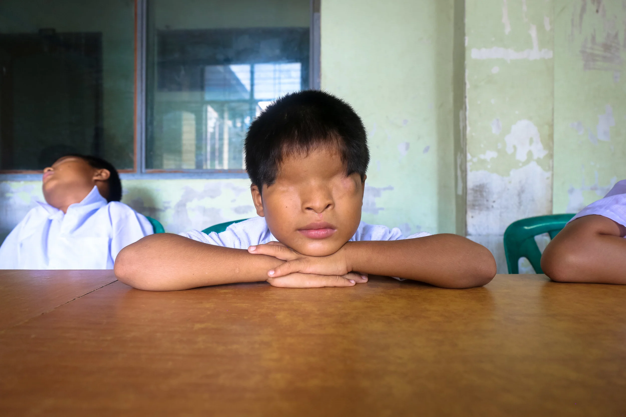 VICTORIA MILKO | www.victoriamilkophoto.com | @thevmilko A pupil at the Kyi Myin Dine School for the Blind in Yangon, Myanmar, listens to his teacher lecture about Burmese history. The school provides the opportunity for education, housing, and vocational training for visually impaired youth.