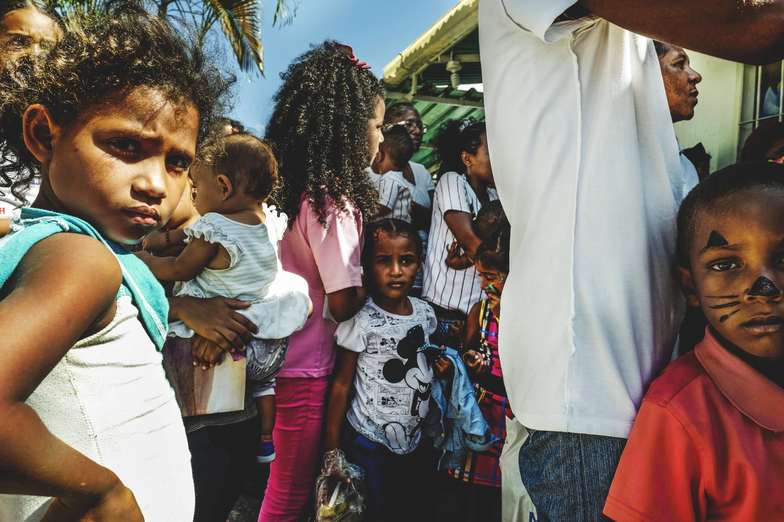 The children of detained men and women wait to enter the center of detention during visitation hours.