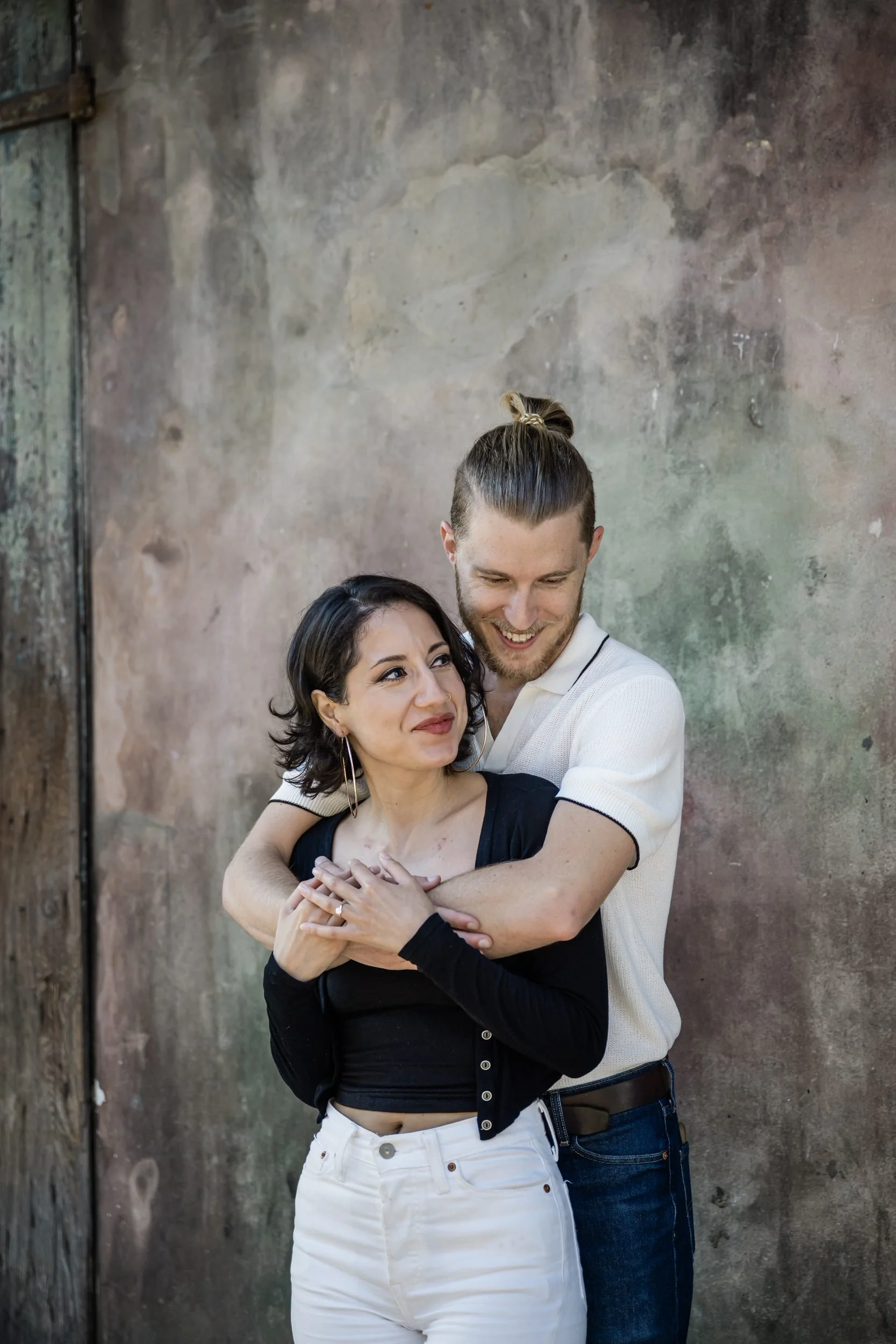 A person hugging their partner from behind