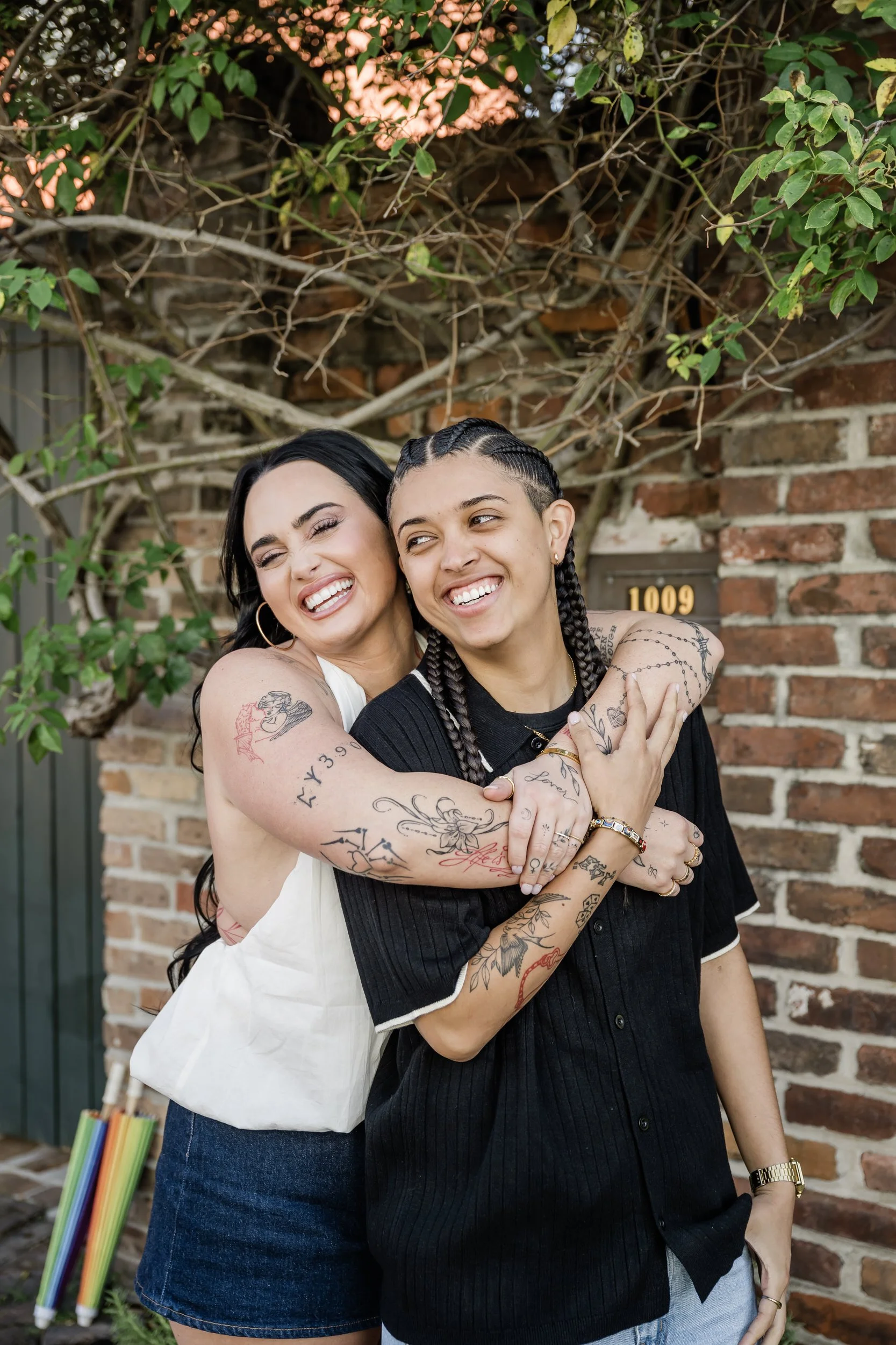 A person hugging their partner from behind as they both smile
