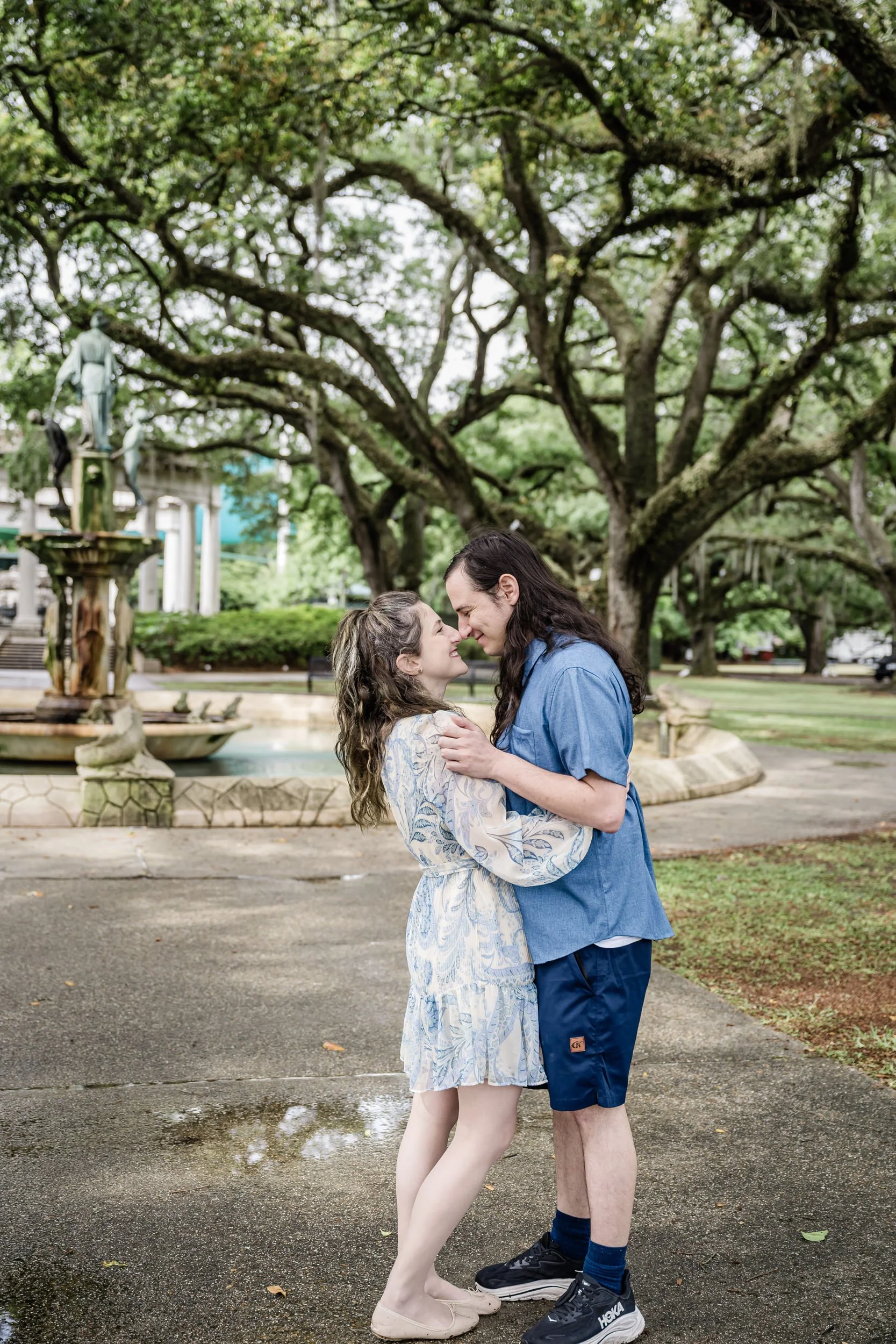 A couple standing nose to nose smiling at each other