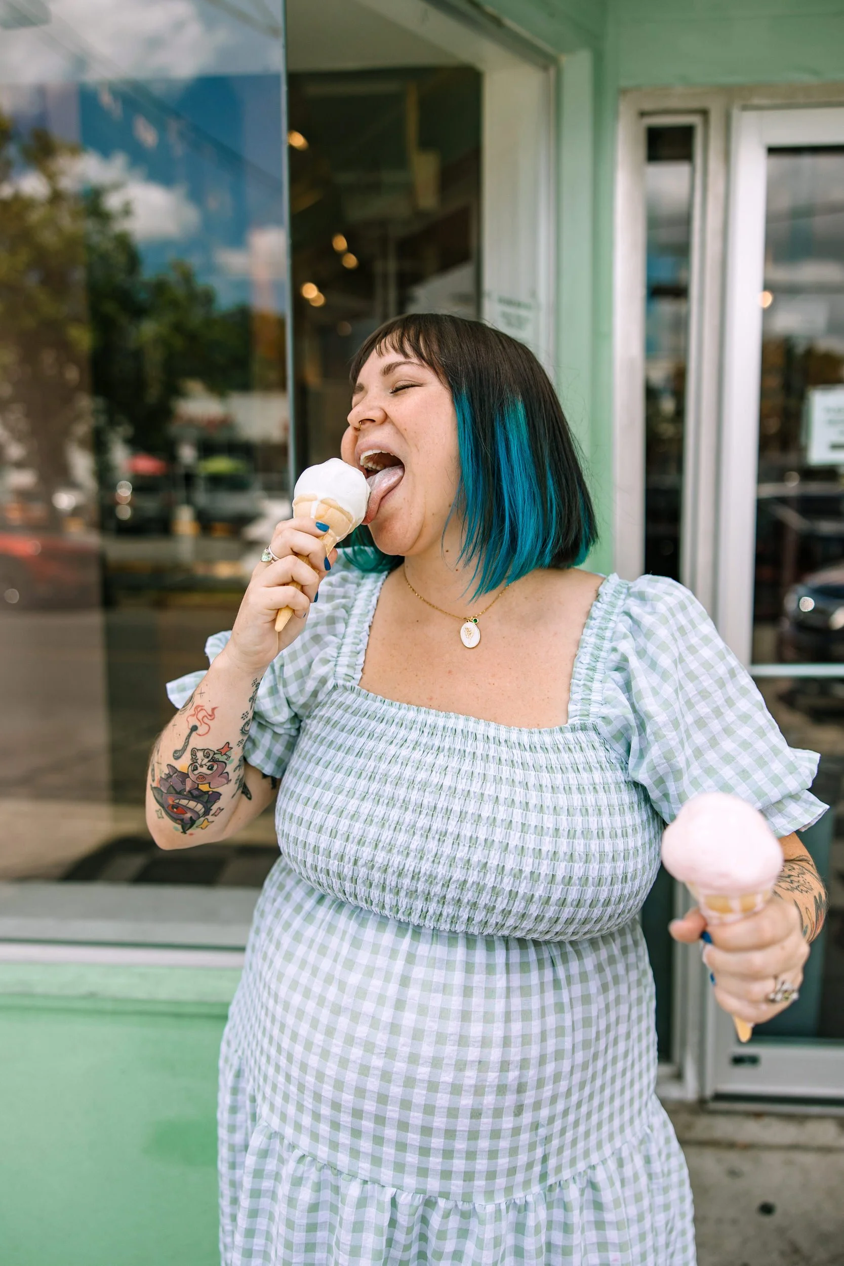 Ash licking an ice cream cone while holding another one in the other hand