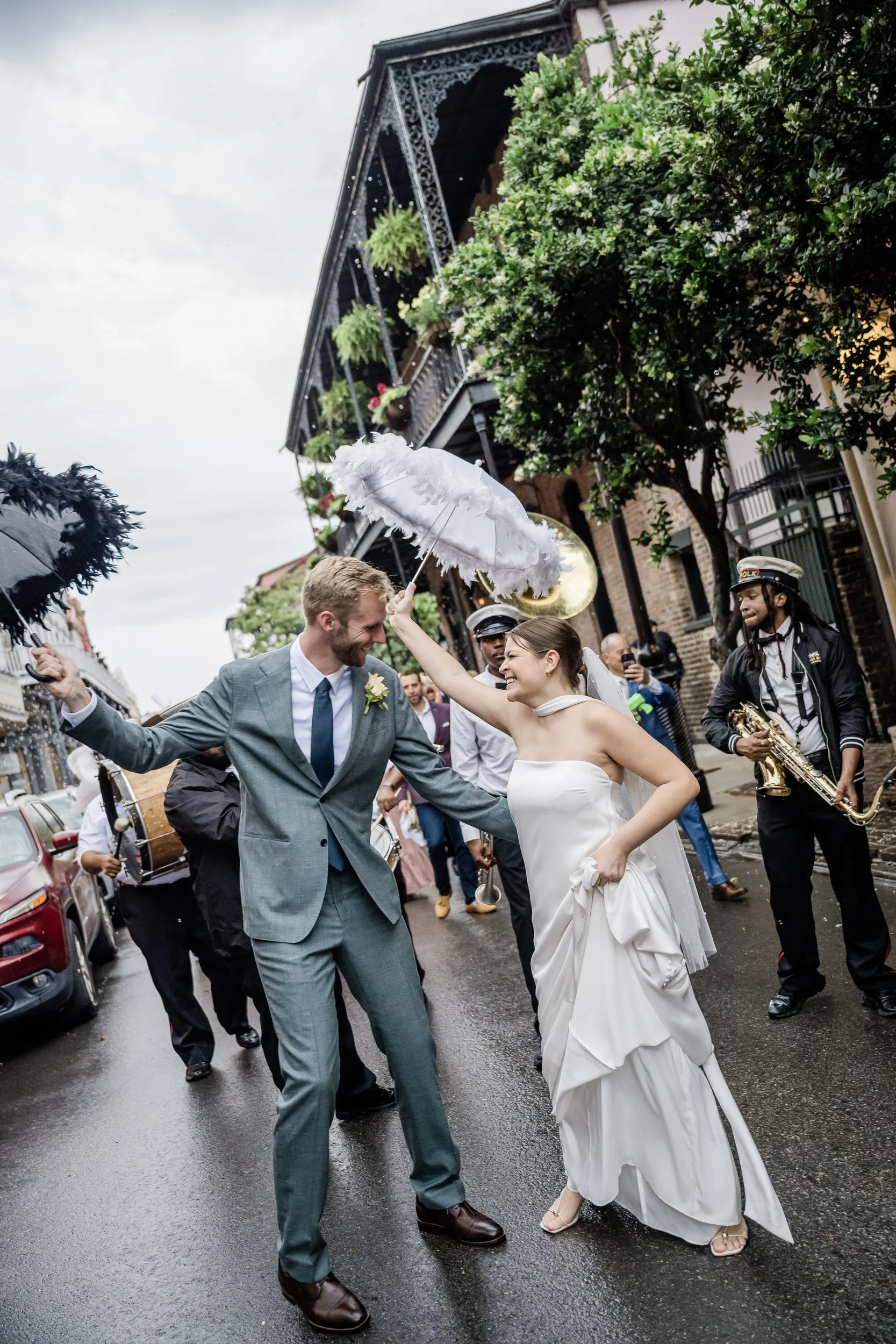 Newlyweds smiling as they march in their second line