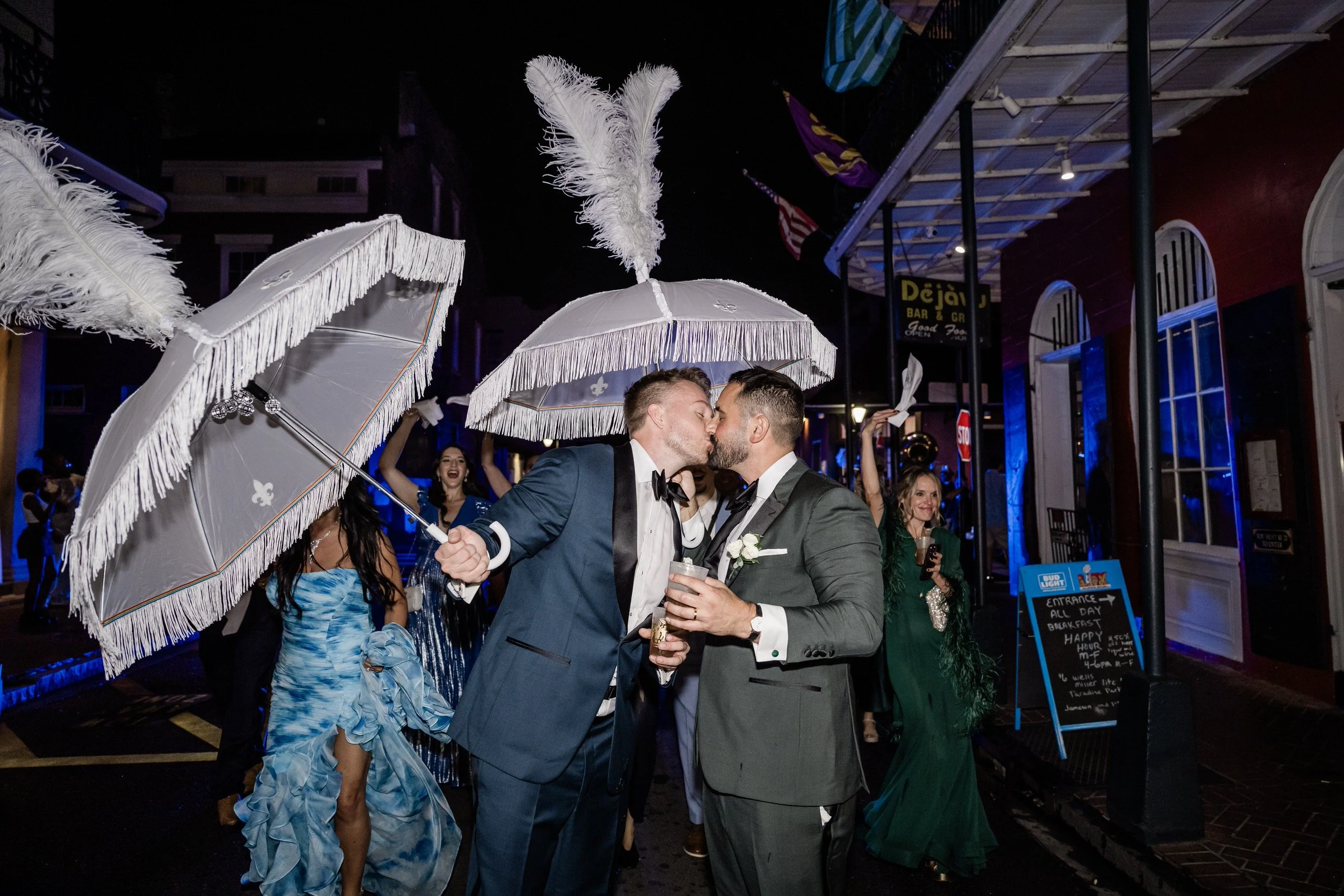 Newlyweds kissing while walking in their second line