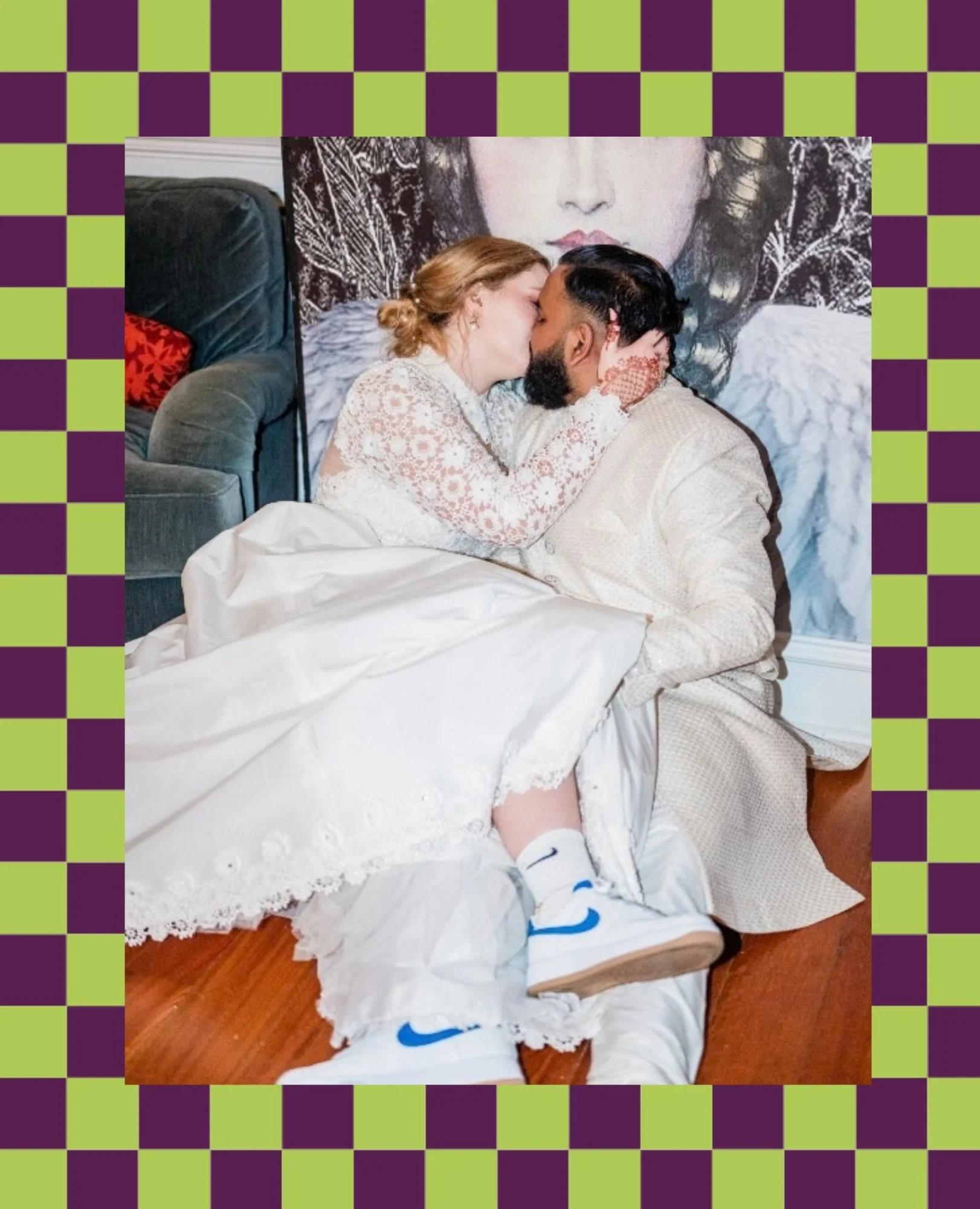 Newlyweds sitting on the floor together as they kiss