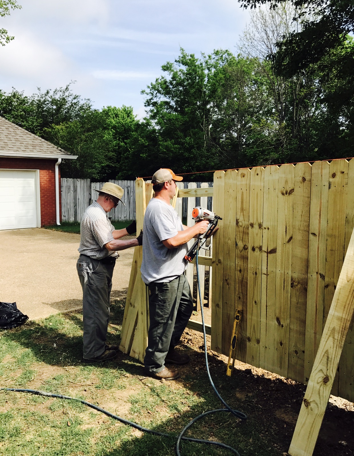  David and Allan Smith fixing the fence and cleaning up the yard. 