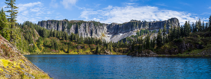 Canon 6D full frame, Canon 17-40mm, heavy setup, hand held, 5 shot panorama merged in Photoshop. Nice documentary photo, but not even remotely worth the weight to this setup. Great example of how your'e only going to get "ok" photos in mid-day light. 