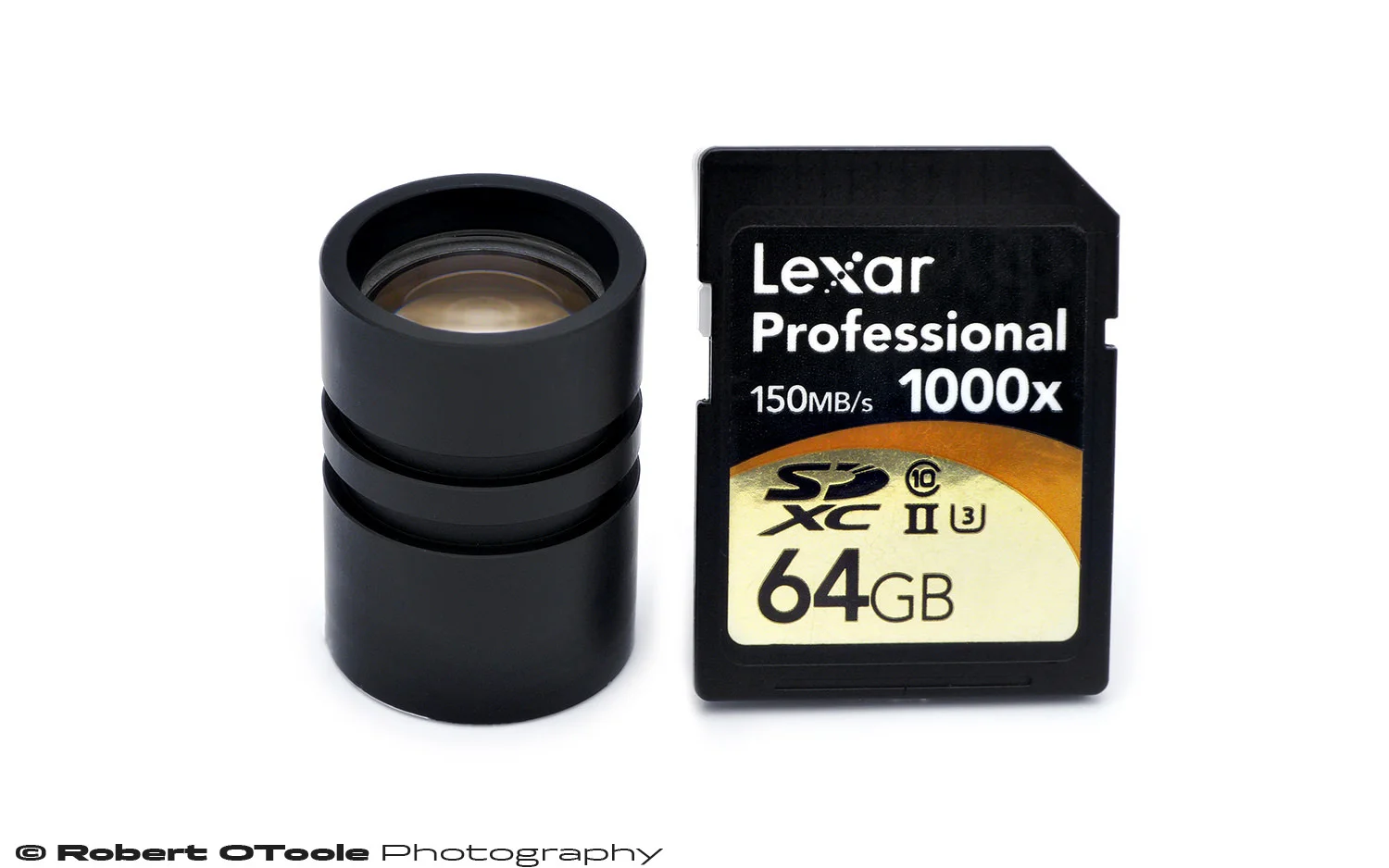 Small enough to hide behind an SD card, the Minolta DiMAGE Scan Elite 5400 scanner lens and SDHC card for scale