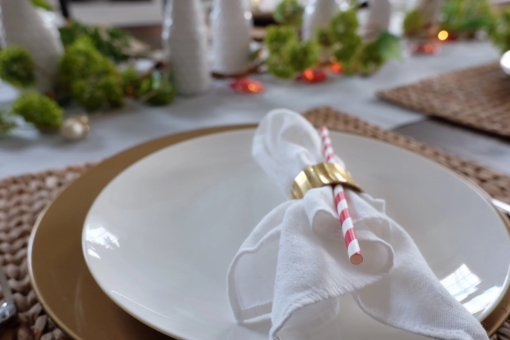 Edges of napkin facing middle of table. Guests can use the straw for their drinks. 