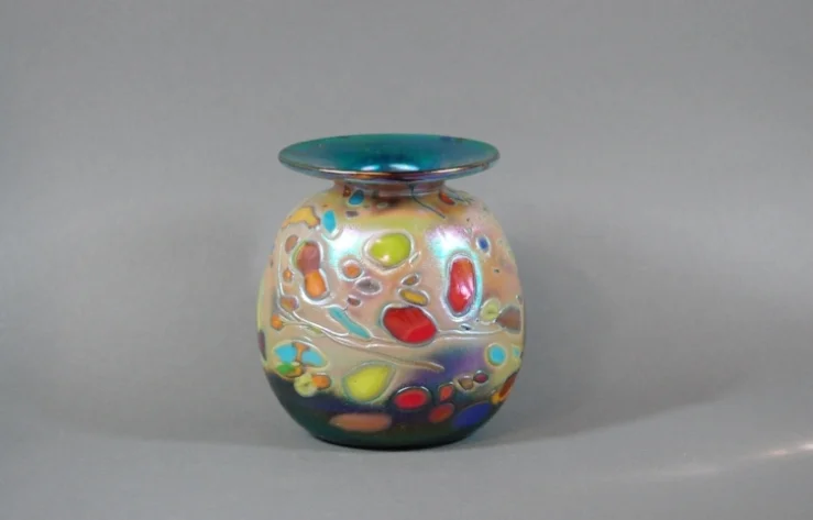 Green vase with multi colored frit.