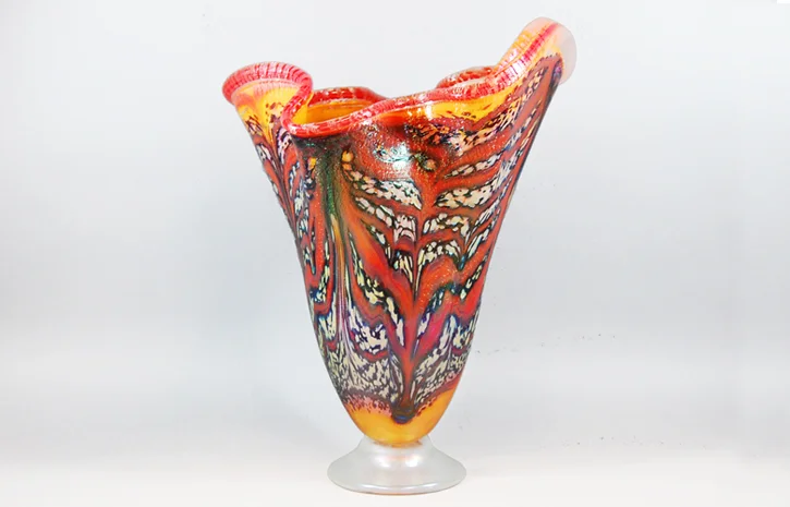 Fluted vase with mango and opaque red veining.