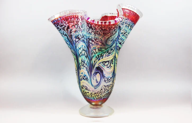   Cherry red vase with silver cobra wraps.