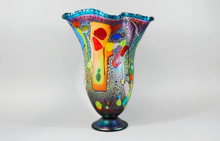 Grape vase with a green lip and fused multi colored glass.
