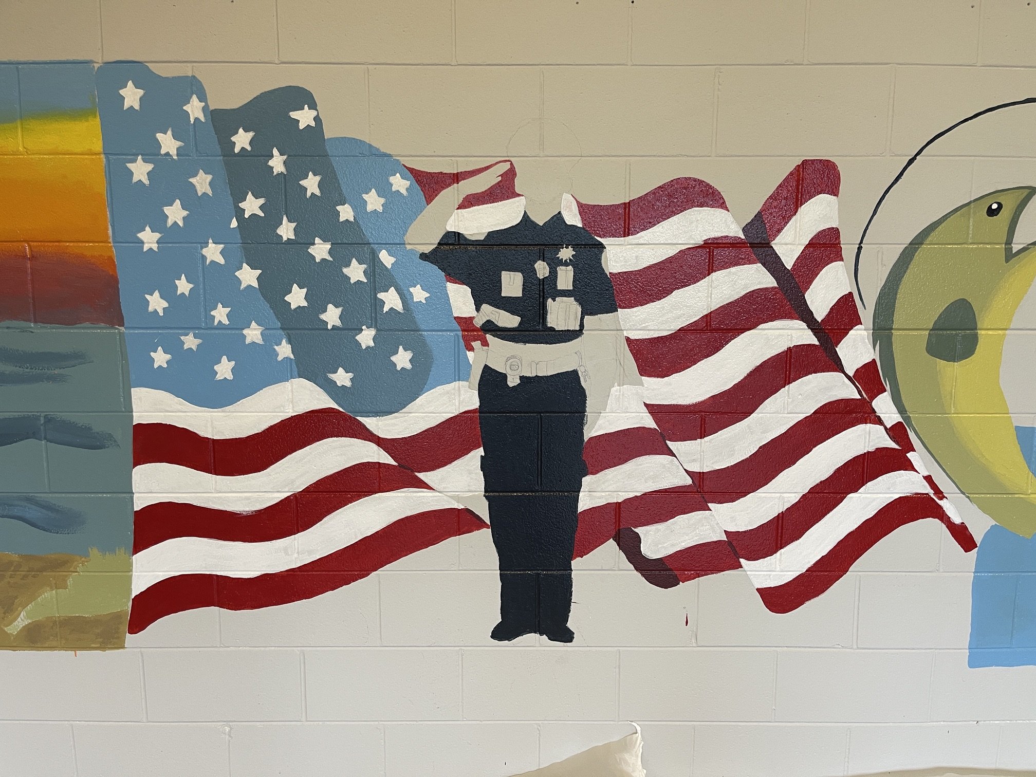 Students designed and painted the mural themselves with my guidance. The mural incorporates imagery connected to the local community, including the police department, Lake Michigan, fishing, and the department’s bee mascot.

The police department fun