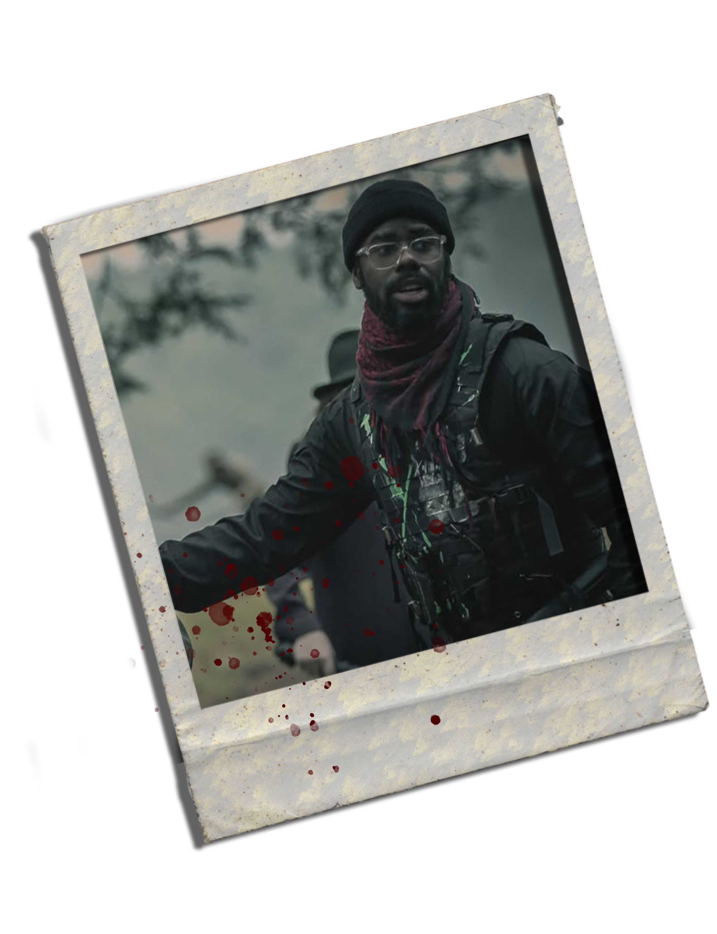 A man wearing glasses, a beanie, and a red scarf, outdoors in cold weather, with a serious expression, surrounded by trees with misty background.