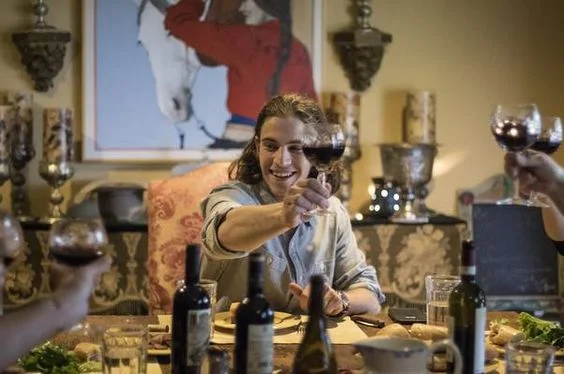 Jack Matusek and his French companions share a glass of wine