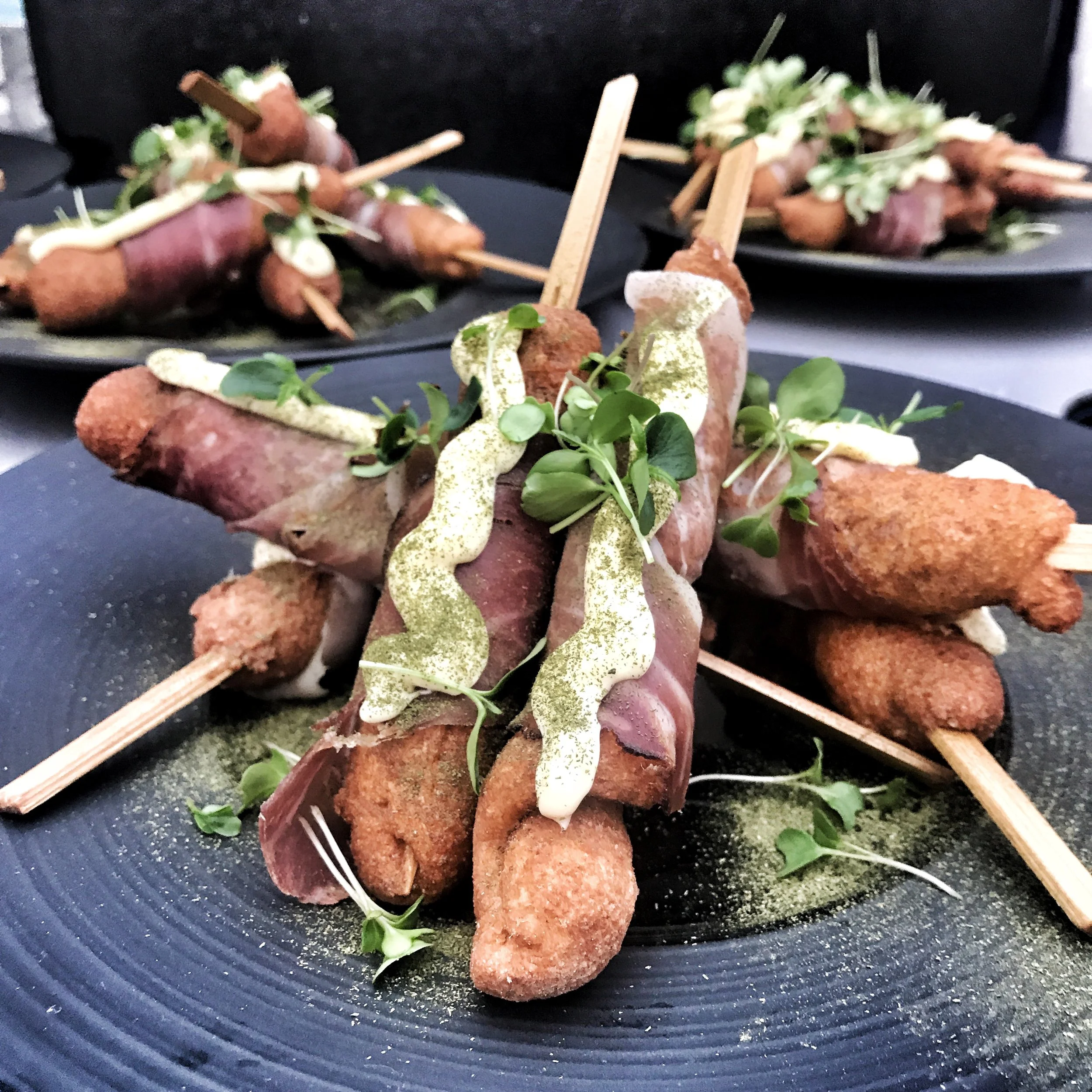 Snogbrød (snake bread) wrapped with two year old prosciutto.