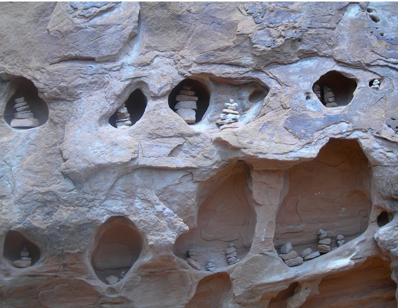 cairnsInGreyRockWall_image.jpg
