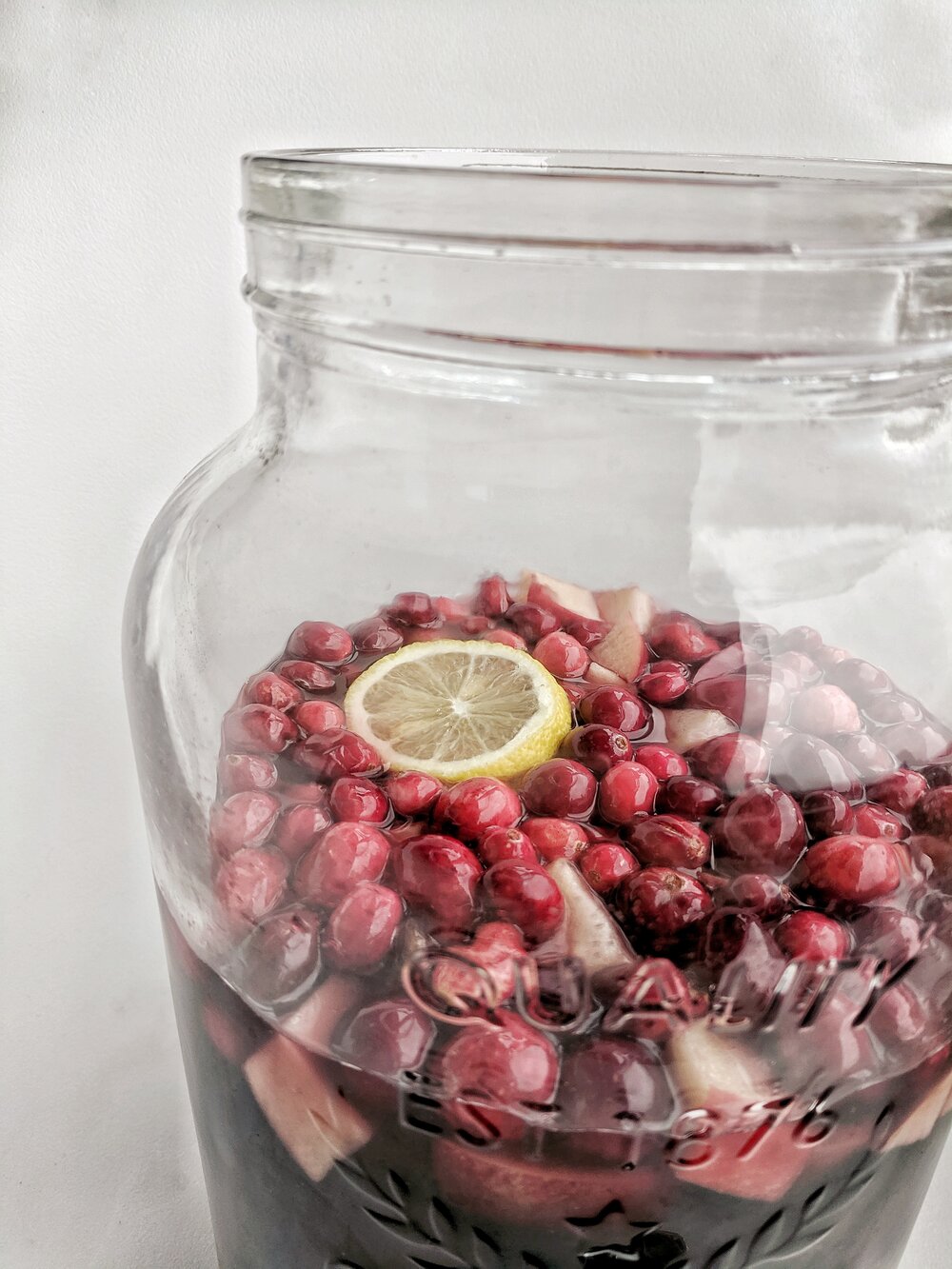 cranberry sangria in glass dispenser