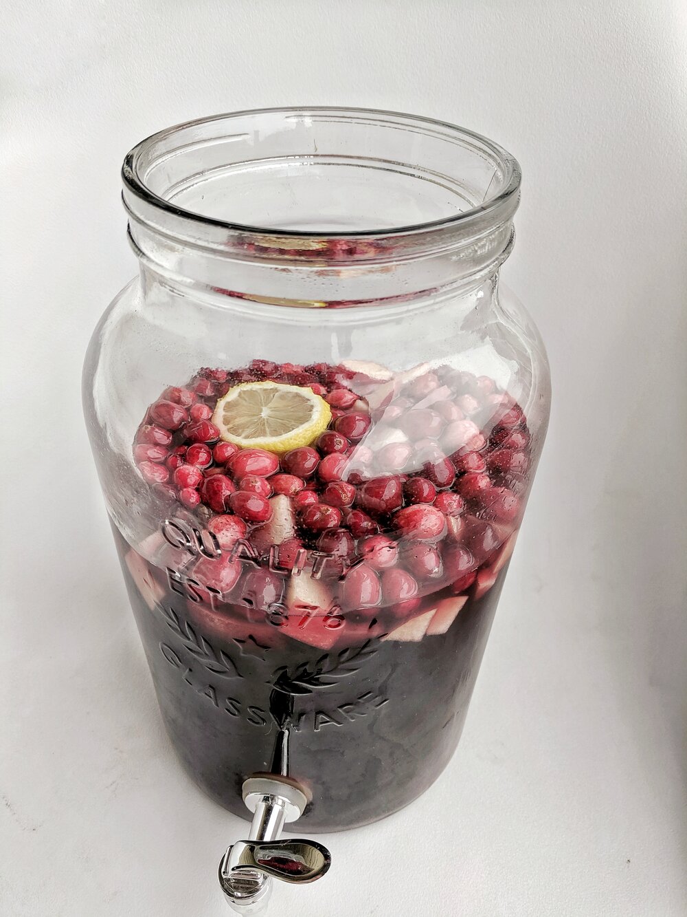 Cranberry Sangria in glass dispenser