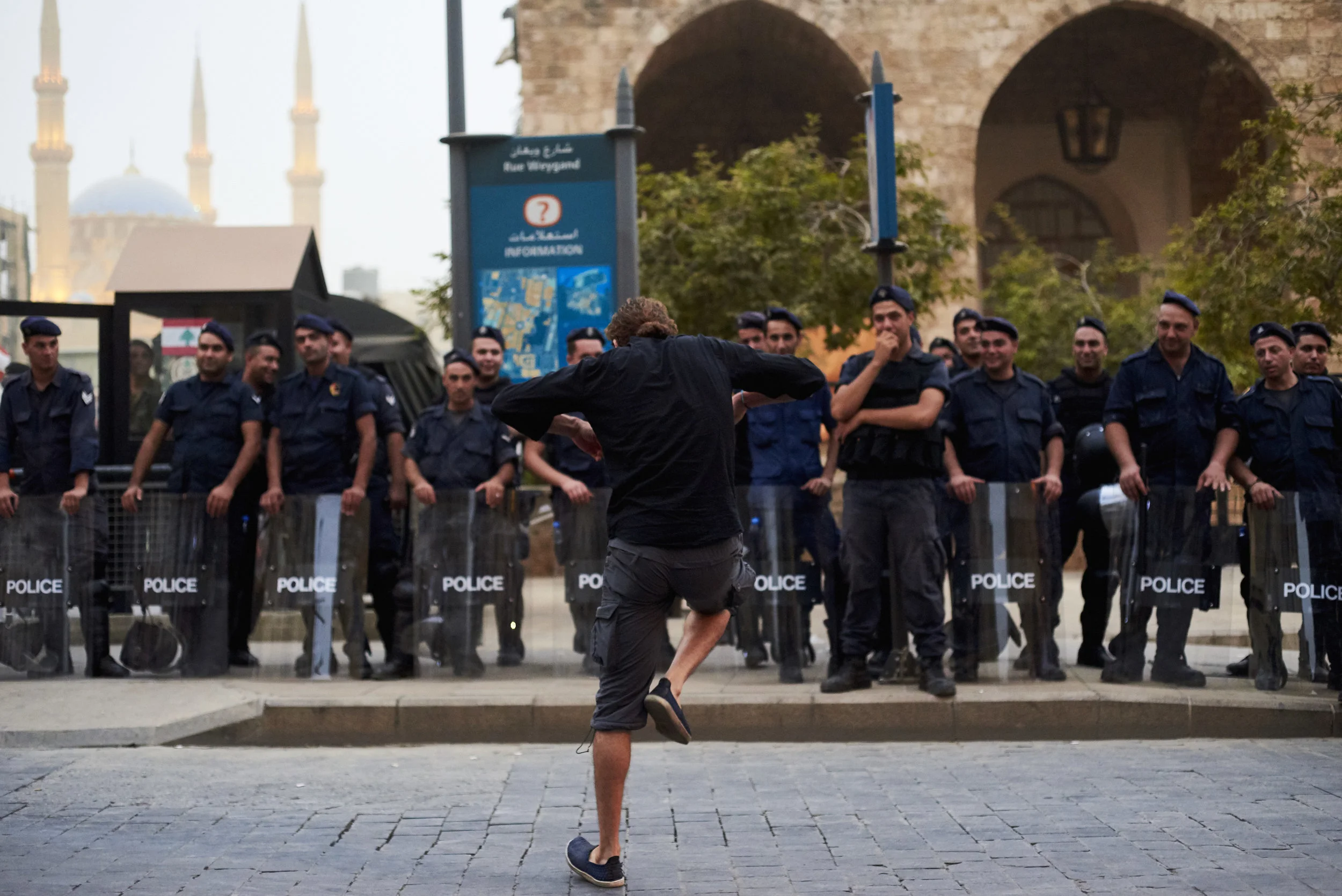 A man dance in front of riot police officers during a "You Stink" rally in Downtown Beirut, Lebanon, August 2015.