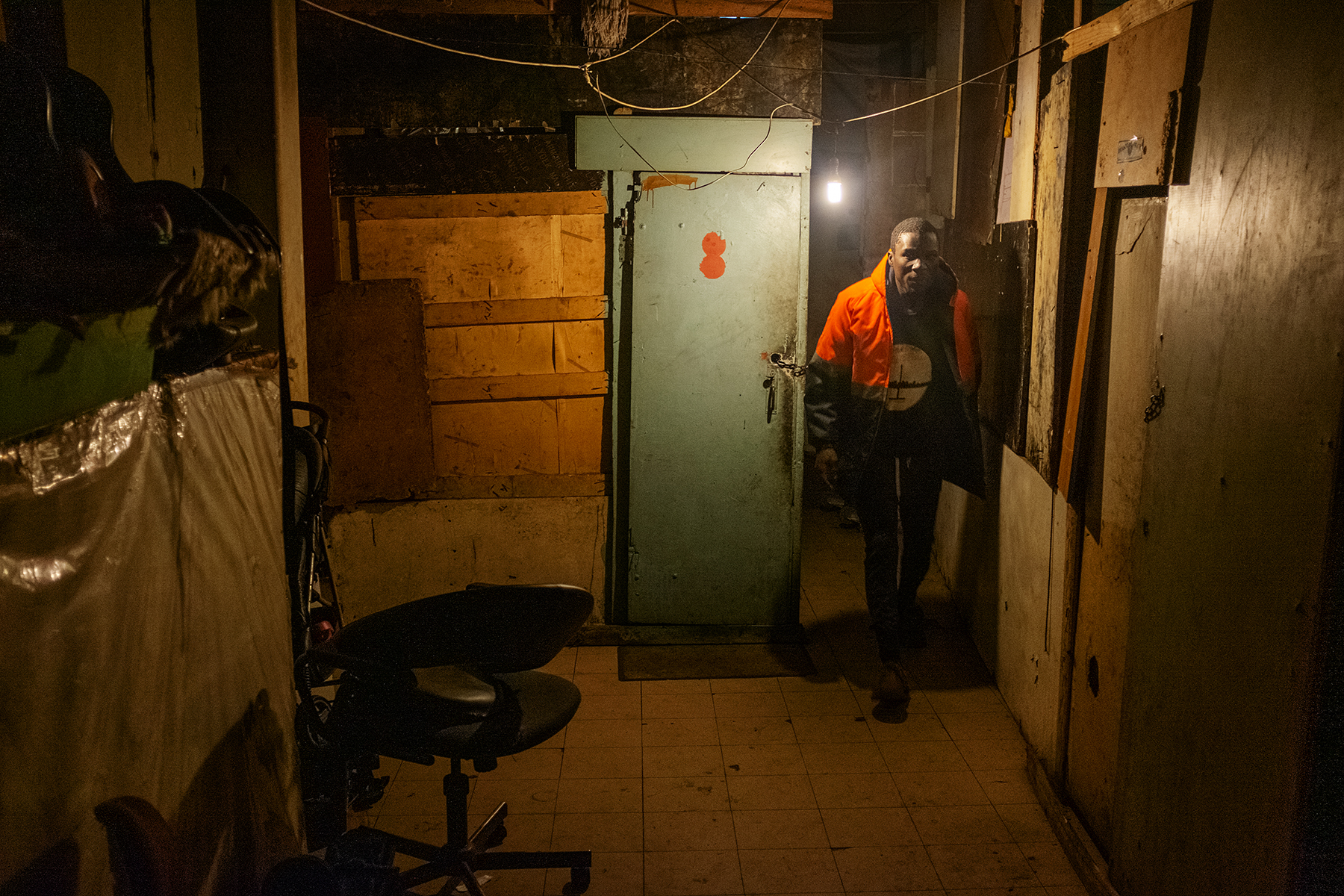 Scelo Sithole, 38, leaves his quarter at the Newtown hostel complex in the early morning of June 12, 2019, to start his day as an informal waste picker in Johannesburg, South Africa.
