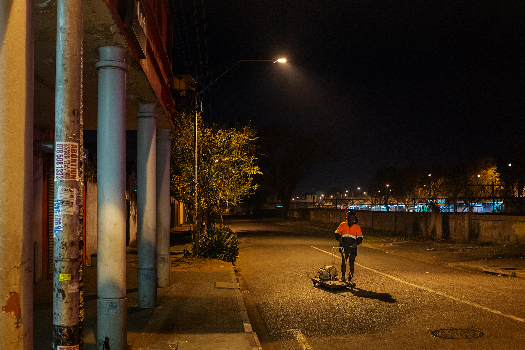 Scelo Sithole, 38, walks carrying his trolley in the streets of Johannesburg, South Africa, in the early morning of June 12, 2019, to start his day as an informal waste picker.