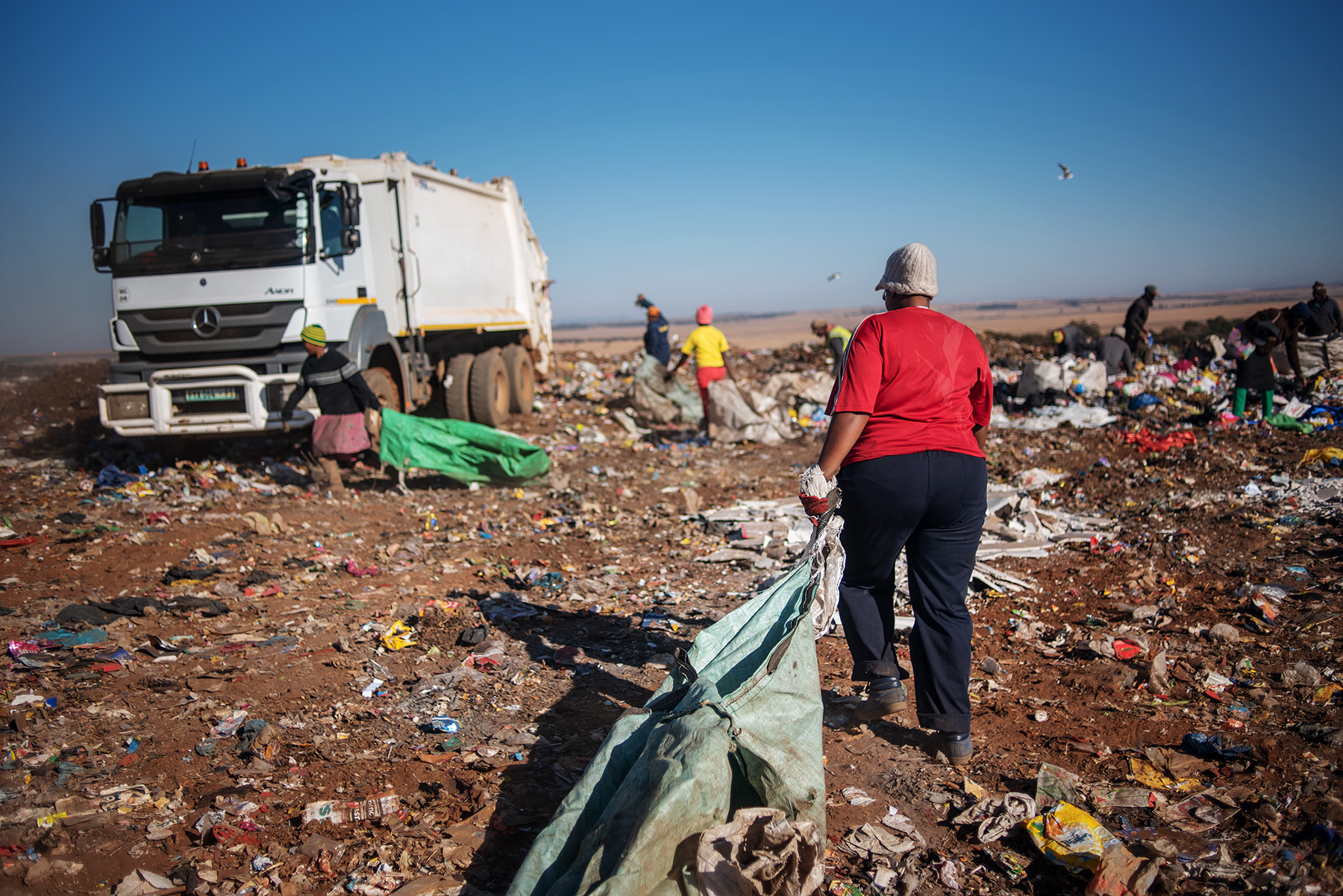 Eva Mokoena, a 33 years old South African informal waste picker, approaches a garbage truck at the Palm Springs landfill in the outskirt of Johannesburg, South Africa, on June 28, 2019.
