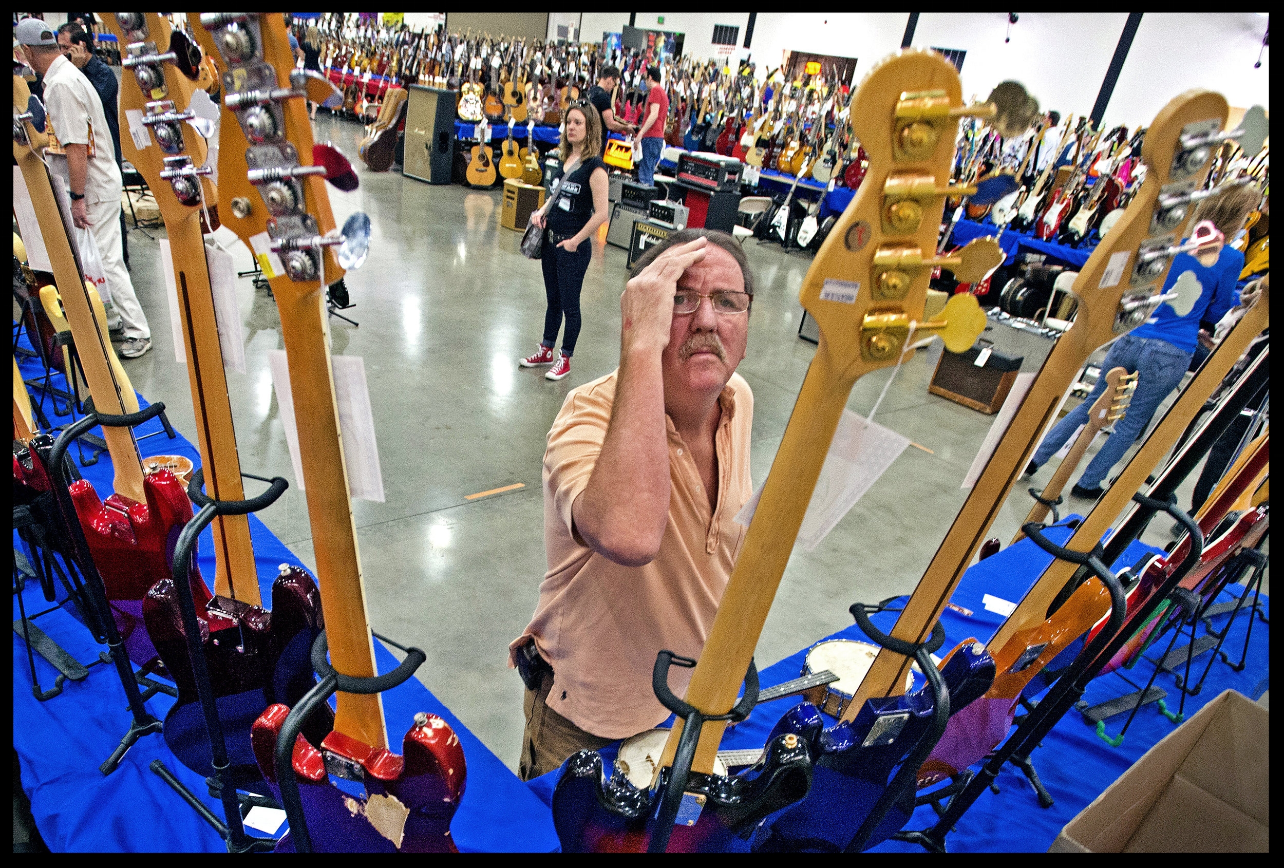 Ike Soffes of San Clemente gets a close look a bass guitar during the SoCal World Guitar Show at the OC Fair and Event Center in Costa Mesa on Sunday. According to the shows promoter, Larry Briggs, there were close to 4000 guitars available at the show for purchase or trade.