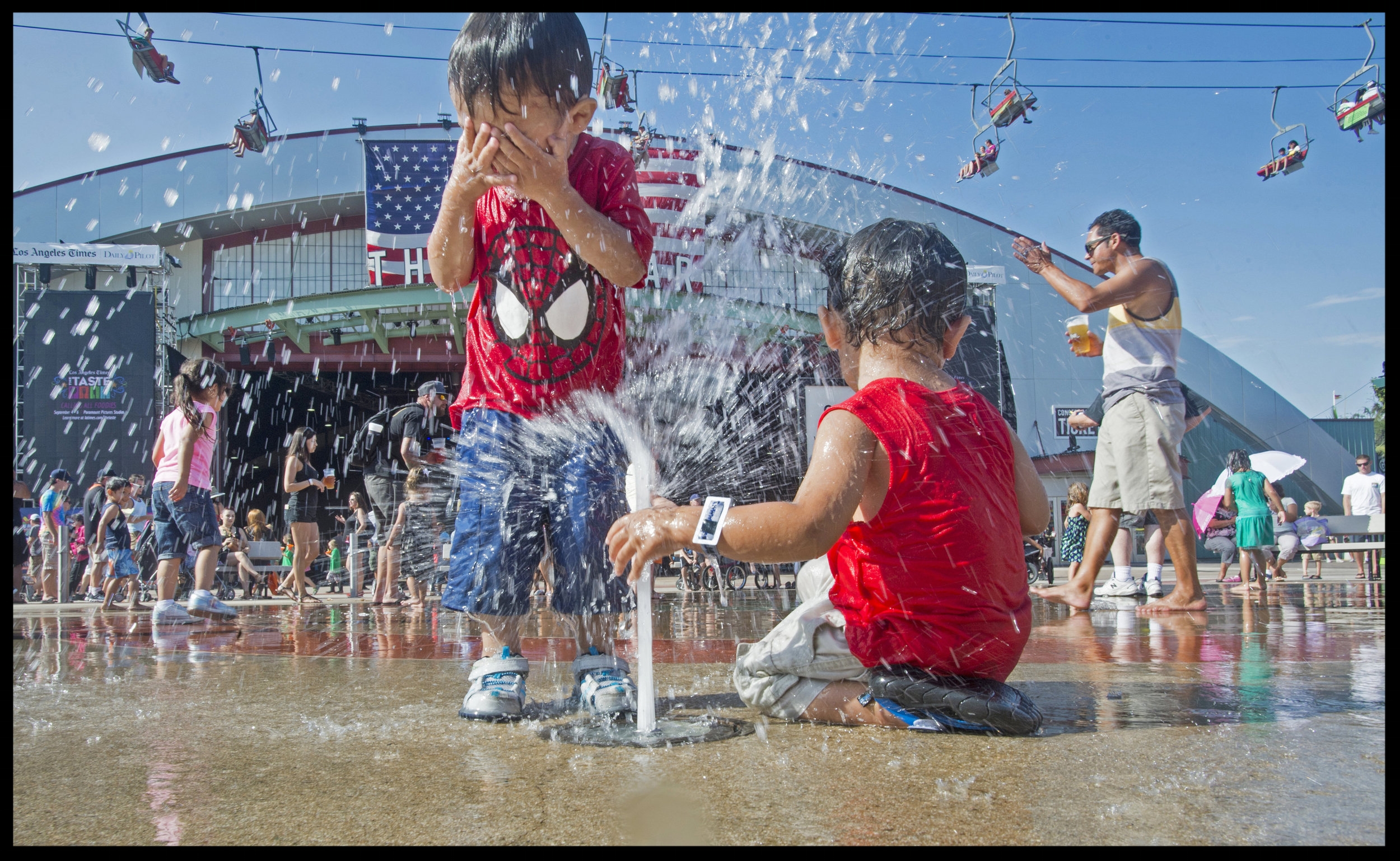 Kids play in the fountain found at the center of the fairgrounds the Orange County Fair & Event Center. This water is cleansed and re-serviced.