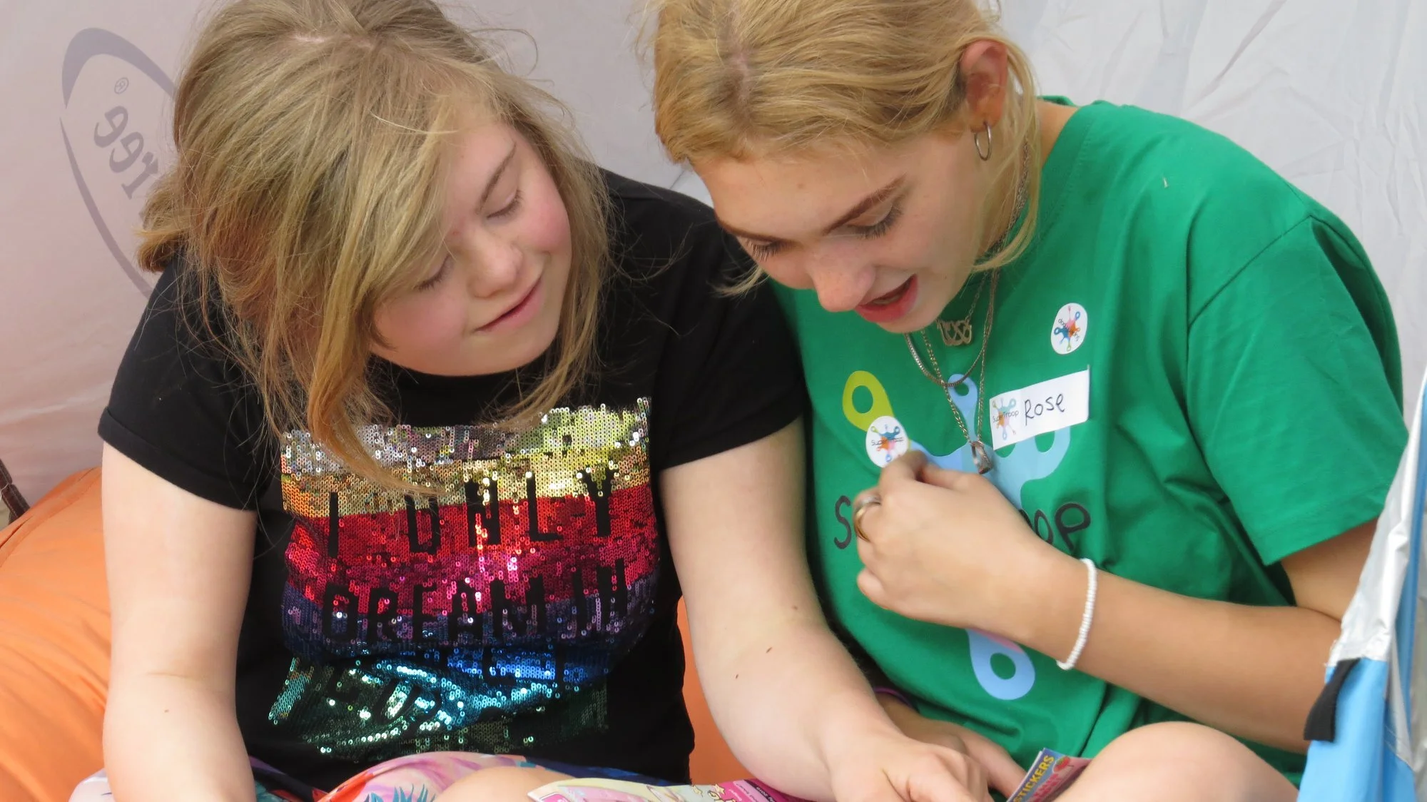 a holiday-maker and a volunteer reading a story together