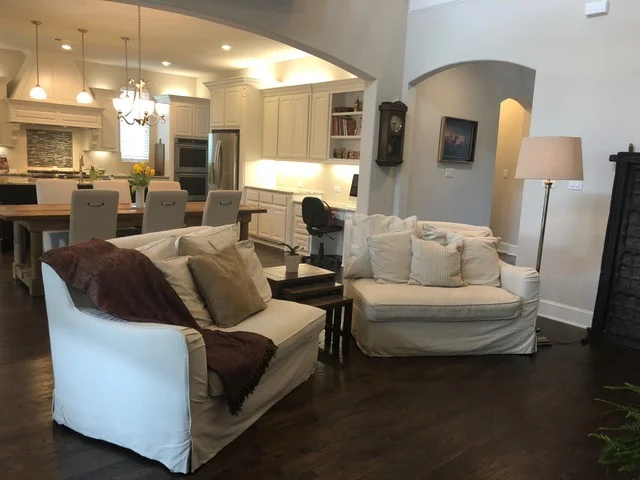 Here, we split the couch up into two pieces giving the family room a more open feel. A small table between the two helps section off the living room from the dining space. Lamps. Lamps are huge! They add light which every room needs. And if a room doesn't have much natural light, lamps and reset lighting can help brighten the room. Think light and airy, not dark and dungeon like! Also notice all counter tops are cleared off. Decluttering counters makes such a difference. It allows for more room while working and gives the feel of organization. Organization = Peace ! Finally, simple live plants and florals are a great touch to any room. It doesn't have to be giant. As a matter of fact, we suggest a small plant or vase sitting on the dining table or at the kitchen sink window. Plants + florals add LIFE! If it dies though, please toss it. A dead plant does not help stage or sell a home! :)