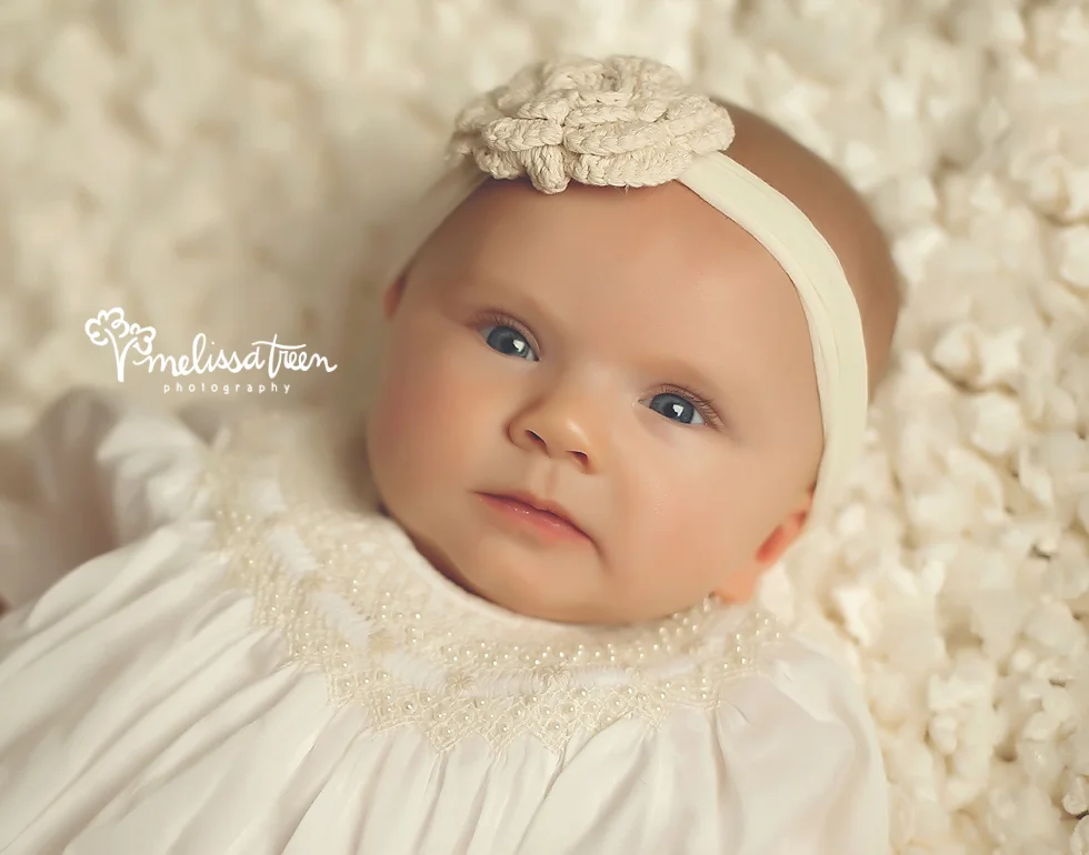 Good morning Miss Blue Eyes! This baby girl visited the studio for her 4 month milestone photo shoot. We are always giddy to see our little baby portrait planners return to the studio and to see how they have grown! Wide awake and completely calm and alert is ho she arrived, she shared plenty of smiles with us, which we will share soon, but I love this little baby gaze. The baby gaze is actually a look I always try to capture. It's signature to the first months of baby's development and defines the beginning of their stage of curiosity where they are visualizing things with curiosity. The end result is a sweet, precious capture I like to call the baby gaze.