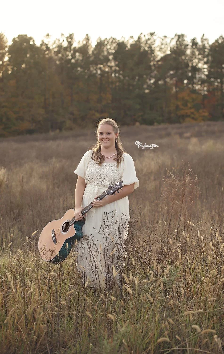 garner-senior-portraits-greensboro-senior-pictures-in-field-with-guitar-browns summit-nc-photographer.jpg